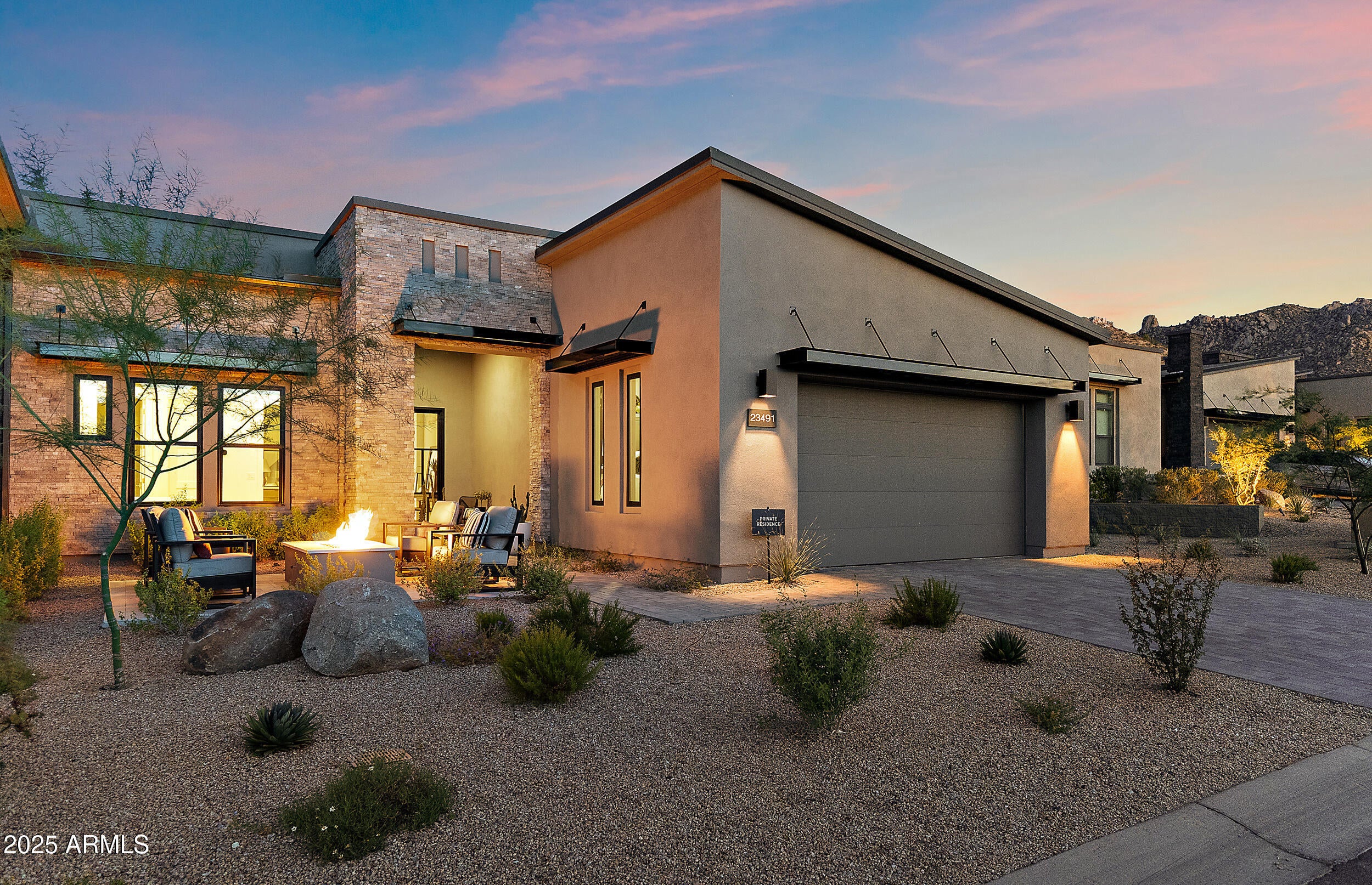Exceptional value in Sereno Canyon — the best price per square foot for a luxury home in this coveted gated community! Experience contemporary desert living at its finest! Lives like brand new construction in sought-after community.

Designed w/ an emphasis on style, comfort, & low-maintenance living - just steps from the Mountain House Lodge, where residents enjoy world-class amenities including pools, fitness center, spa treatments, & fine dining.

Sleek façade accented w/ stonework & welcoming fire pit patio sets the tone for the refined interiors within. Glass front door opens into bright, open layout where great room showcases dramatic floor-to-ceiling fireplace & seamless indoor-outdoor flow. Kitchen highlights Wolf appliances & Taj Mahal backsplash + XL waterfall edge island w/ seating.

Primary features views, walk-in closet, & 5-pc bath including soaking tub, dual vanities & tile surround shower.

Upgraded designer lighting, wide-plank tile floors, & clean architectural lines create a sophisticated yet relaxed vibe.

Outdoor retreat is equally impressive featuring covered patio, custom hardscaping, private spool w/ water feature, & curated succulent wall  all framed by stunning desert & mountain views.

Nearby access to Troon golf, Pinnacle Peak, & Tom's Thumb hiking trails. The perfect blend of resort-style amenities & Arizona's unmatched natural beauty!