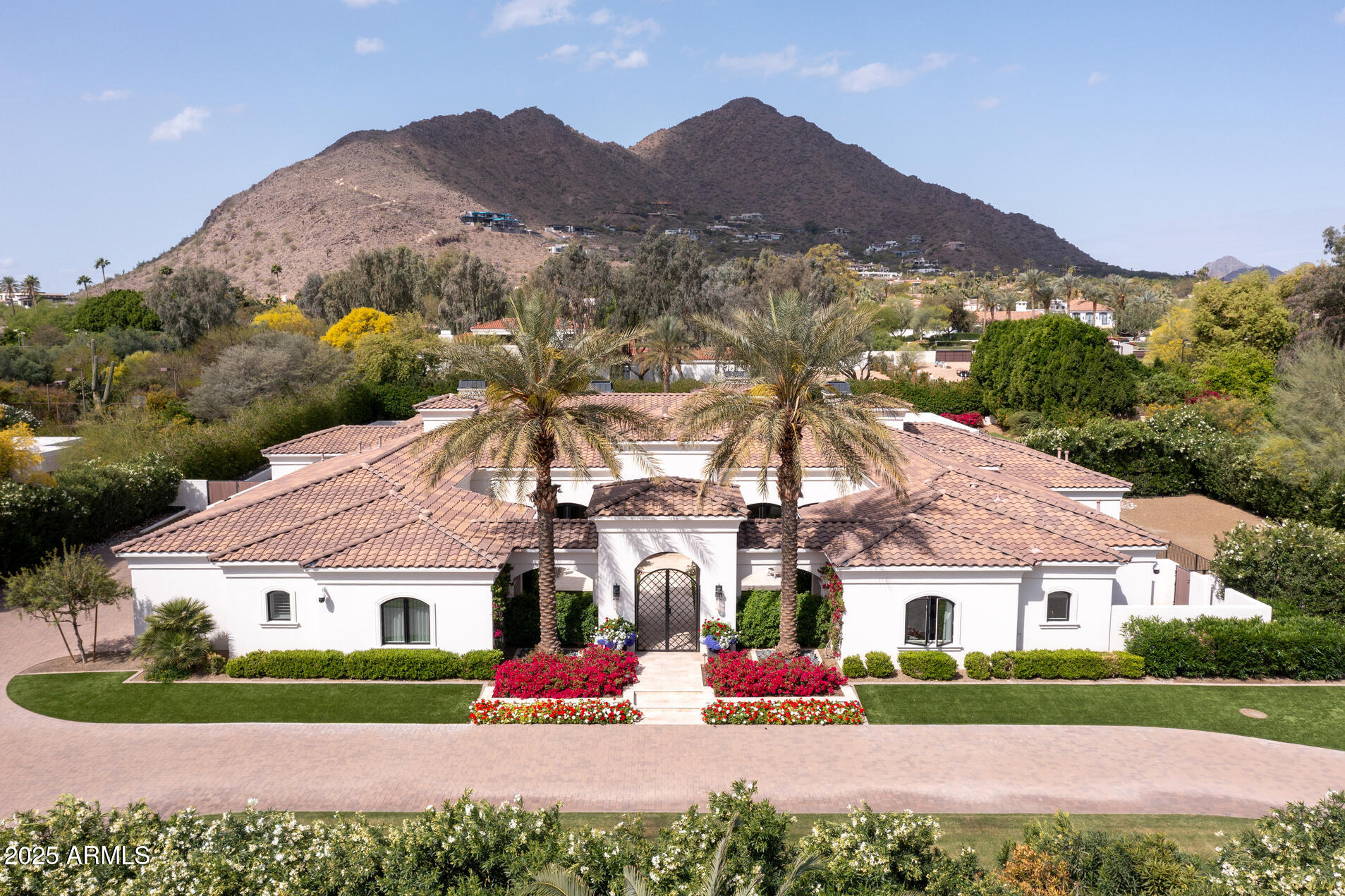 This stunning 10,352 sqft Double-Gated Estate on 1.36 acres with CAMELBACK MTN views, was built in 2017 and additionally updated in 2020. It has 6 bedrms, 8 baths + includes a full GUEST HOME + Guest Casita. Enter the landscaped grounds thru a large front courtyard with beautiful flowers.The primary suite is amazing. It has both a sitting rm w/ wetbar, a gym/ massage rm + a magnificent bathrm with 2 separate marble showers, a fabulous tub, and 2 large custom closets. The open floorplan is anchored by a chef's kitchen w/ Taj Majal marble, Wolf appliances, and dual islands, opening to the fabulous great room w/ pocketing glass doors open to the resort-style backyard w/ an expansive grass area, large pool w/ gazebo, spa, pickleball w/ picnic area, bocce ball, 2 DOG RUNS + multiple seating