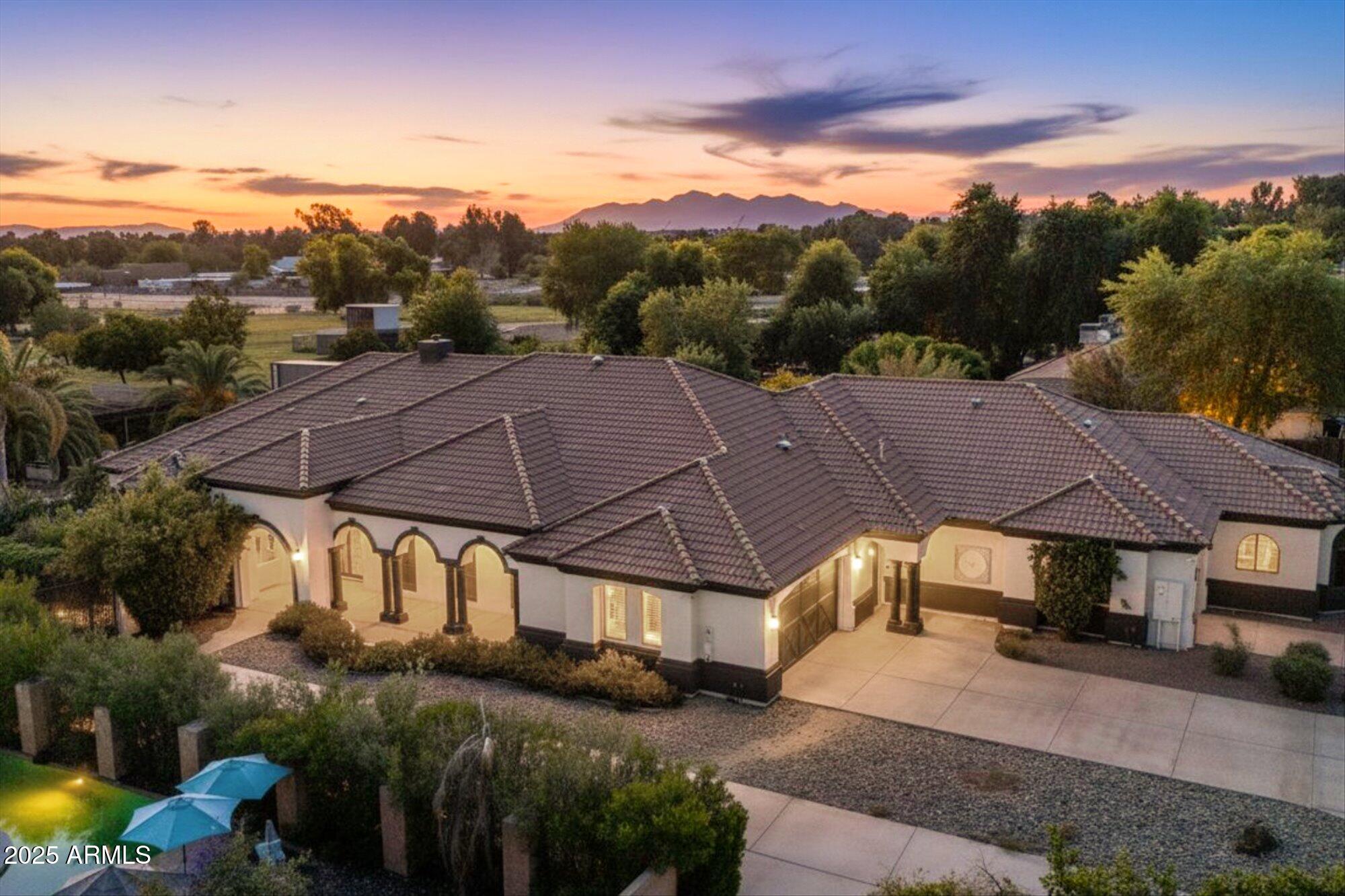 Welcome to a place where luxury living feels effortlessly warm and inviting. Set on nearly two acres of lush, private land in the heart of Romola, this charming horse property blends elegance, comfort, and Arizona beauty in perfect harmony. The home greets you with fresh exterior paint, a manicured yard, and a spacious three-car garage, setting the tone for the thoughtful details found inside. Step through the door and feel an instant sense of home. The living room's decorative wood beams, cozy fireplace, and soft natural light create a space that's both refined and perfect for gathering with friends or unwinding after a long day. The gourmet kitchen is a showstopper, featuring tall cabinets, stainless steel appliances, granite...CONTINUE READING... .....counters, and a large island that invites conversation over morning coffee. Just off the kitchen, a charming breakfast nook, comfortable family room, and private den offer versatile spaces for work or play. The primary suite is your own private retreat, with patio access, a spacious walk-in closet, and a luxurious ensuite adorned with dual sinks and elegant granite finishes. Every detail feels designed with both comfort and sophistication in mind. Step outside to your personal oasis an entertainer's dream and a peaceful escape all in one. The resort-style backyard features a sparkling lap pool, relaxing spa, built-in BBQ and bar, gazebo, putting green, and firepit for cozy desert evenings under the stars. With five well-kept horse stalls, irrigated grounds, and plenty of room to roam, this property offers the perfect blend of country charm and modern luxury. Beautiful, welcoming, and full of heart this is more than a house. It's the kind of home that feels like it was meant just for you.
SEE DOCUMENTS TAB FOR LIST OF UPGRADES