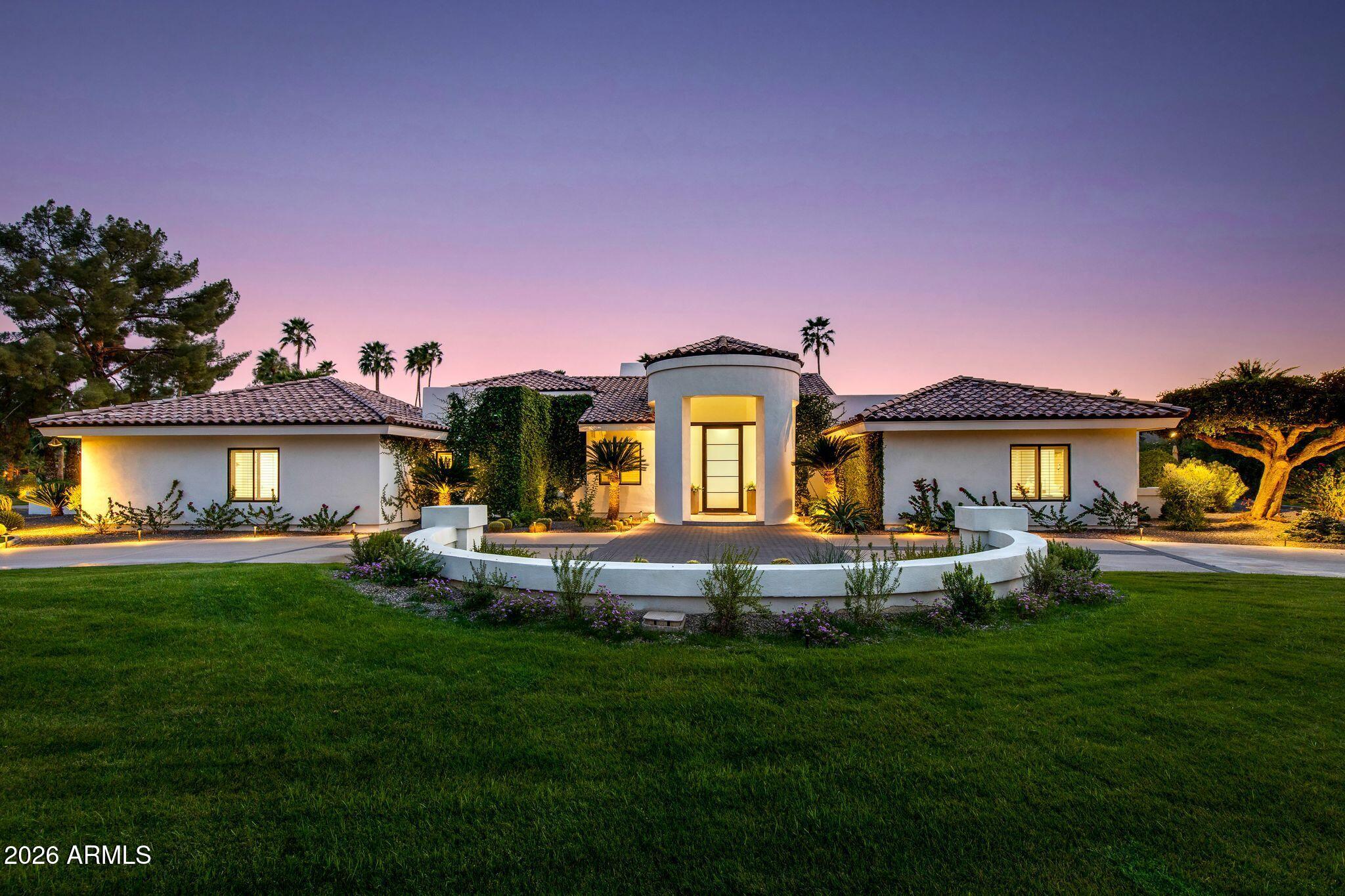Located on a quiet and charming street, this move-in-ready residence blends exceptional quality and thoughtful design with Arizona's signature indoor-outdoor lifestyle. Originally reimagined in a comprehensive 2018 remodel, the home has been further elevated with quality upgrades, reflecting a meticulous attention to detail throughout. Just beyond the entry, a grand living room with soaring ceilings and a dramatic double-sided fireplace opens seamlessly to the outdoors, creating the perfect setting for both intimate evenings and entertaining. 
The beautifully appointed kitchen features quality custom cabinetry and a center island with seating, serving as both a functional workspace and natural gathering point. The primary wing offers a bedroom or flex space in addition to the luxurious primary suite. The primary bathroom is a timeless sanctuary featuring marble countertops, a freestanding tub, and two oversized walk-in closets. In the secondary wing, two well-appointed bedrooms and a beautifully designed powder room provide comfort for family or guests. Beyond the main house, a versatile detached casita with its own bathroom provides the ideal footprint for a private guest retreat, executive home office, fitness studio or creative space.
The lush backyard is a destination in itself, centered around an oversized pool and spa complemented by an accent fireplace. Whether you are enjoying a quite evening or hosting a sunset soirée, this home offers a desired lifestyle curated for comfort and effortless desert living.