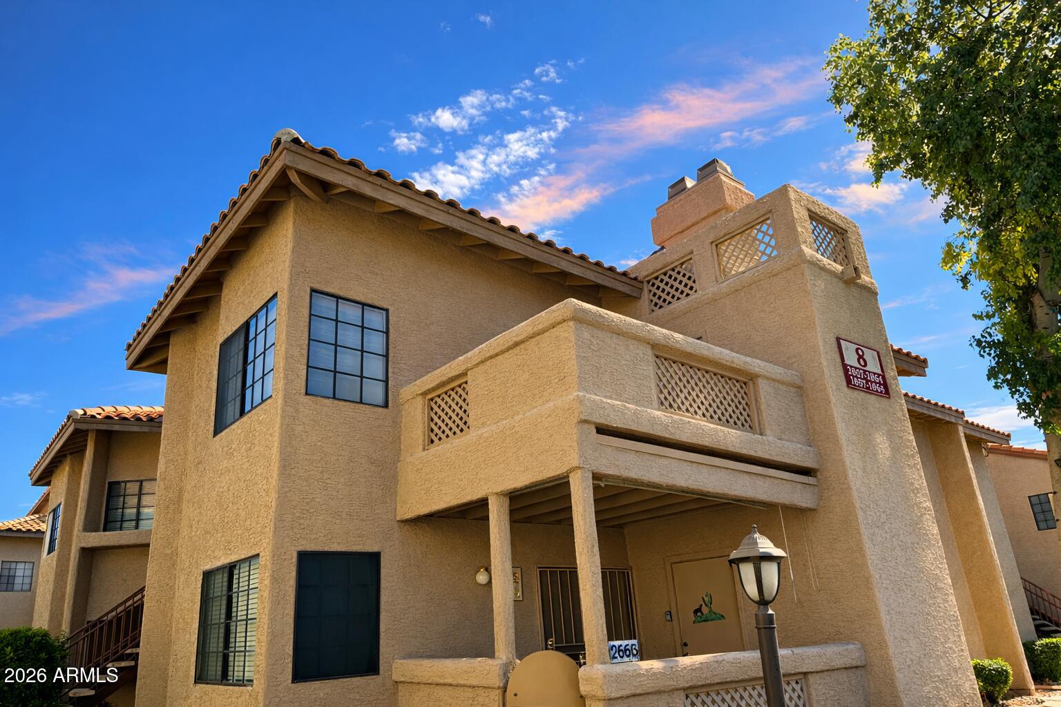 Upper-level condo in a resort-style community featuring LVP flooring in kitchen, dining, and hall, newer carpet in living areas and bedrooms, and a cozy wood-burning fireplace. Kitchen includes GE Spacemaker microwave, Whirlpool glass-top range, Kenmore refrigerator with ice maker, stainless dishwasher, upgraded lighting, and breakfast nook with chandelier. Two bedrooms with mirrored closets, two full baths with upgraded lighting, indoor laundry, and Carrier HVAC. West-facing balcony offers sunset views plus storage closet. Convenient courtyard access and community amenities nearby. Ask your agent for the full photo package and 3D tour.