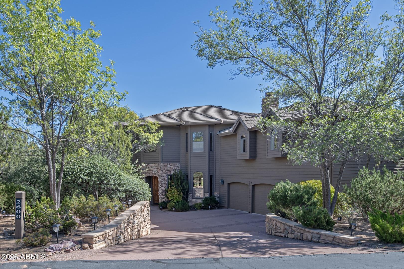 Discover the Ultimate Resort-Style Mountain home for the family who deserves it all. This exquisite 5 bedroom , 4 1/2 bath gem, nestled  in the prestigious Golf Club of Chaparral Pines, offers breathtaking mountain views, lush mature landscaping, and a prime overlook of the 4th green of the golf  course. Warmth and sophistication define this perfectly appointed home magnificently designed interior featuring two Master ensuites and three guest rooms.  An entertainer's gourmet kitchen boasting double ovens, side-by-side refrigerators, custom cabinets and granite counter tops along with a grand gathering room with striking stone fireplace are ideal for unforgettable moments with family and friends. The expansive and immaculate 3 car garage is spacious enough for a golf cart and winter toys.