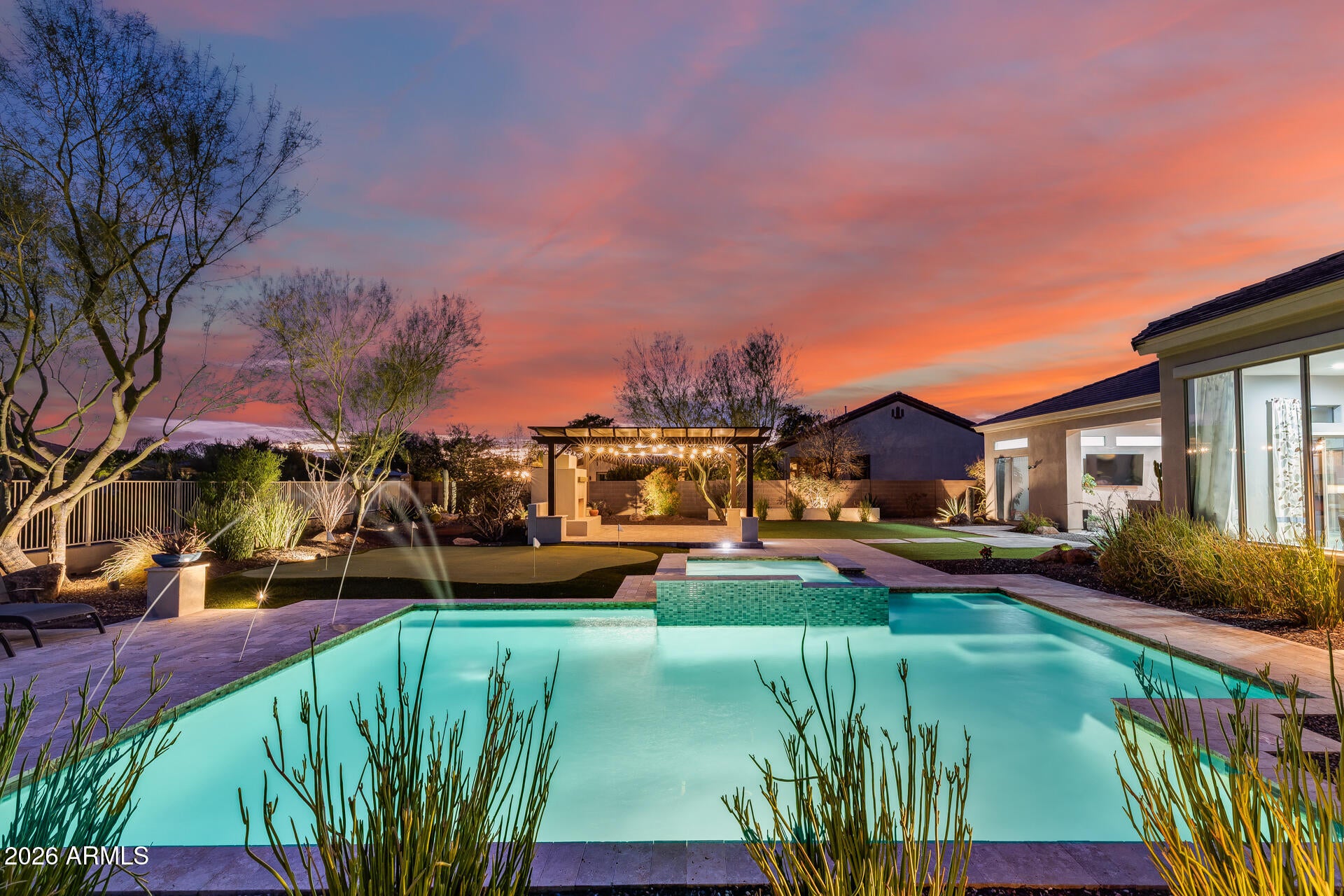 Seller is offer $25,000 towards buyers closing cost with acceptable offer!!
This stunning 4-bedroom, 3-bath residence offers 3,985 sq ft of refined living space on an expansive 18,861 sq ft cul-de-sac lot, showcasing sweeping mountain and wash views and exceptional curb appeal with a travertine paver walkway and grand double-door entry. Inside, enjoy 12-foot ceilings throughout, a desirable split floor plan, and large picture windows that flood the home with natural light and frame the serene backyard. Beyond the four true bedrooms, the home offers multiple versatile flex spaces, including a dedicated gym room, a private office, and a thoughtfully designed laundry room with built-in desk--ideal for a home office, study area, or butler's pantry/mudroom setup. These spaces of incredible flexibility for today's work-from-home or multi-use lifestyle. The chef's kitchen features granite slab countertops, a large breakfast bar, maple raised-panel cabinetry, a beautiful backsplash, a spacious pantry, and a butler's pantry off the formal dining area. A private guest wing with two generously sized bedrooms adds comfort and privacy, while the primary suite boasts a bay window and direct access to the covered patio. The living room also opens seamlessly to the outdoors through French sliders. The resort-style backyard is made for entertaining with a huge covered patio, synthetic grass, travertine pavers, a raised patio area, and an outdoor fireplace - all set against stunning desert and mountain views. Recent updates include a new A/C unit, EcoWater soft water system, garbage disposal (2025), full exterior repaint, and new carpet throughout (2024). Additional upgrades available - see attached list for full details. This exceptional home truly has it all. BRING US AN OFFER TODAY!!!!
