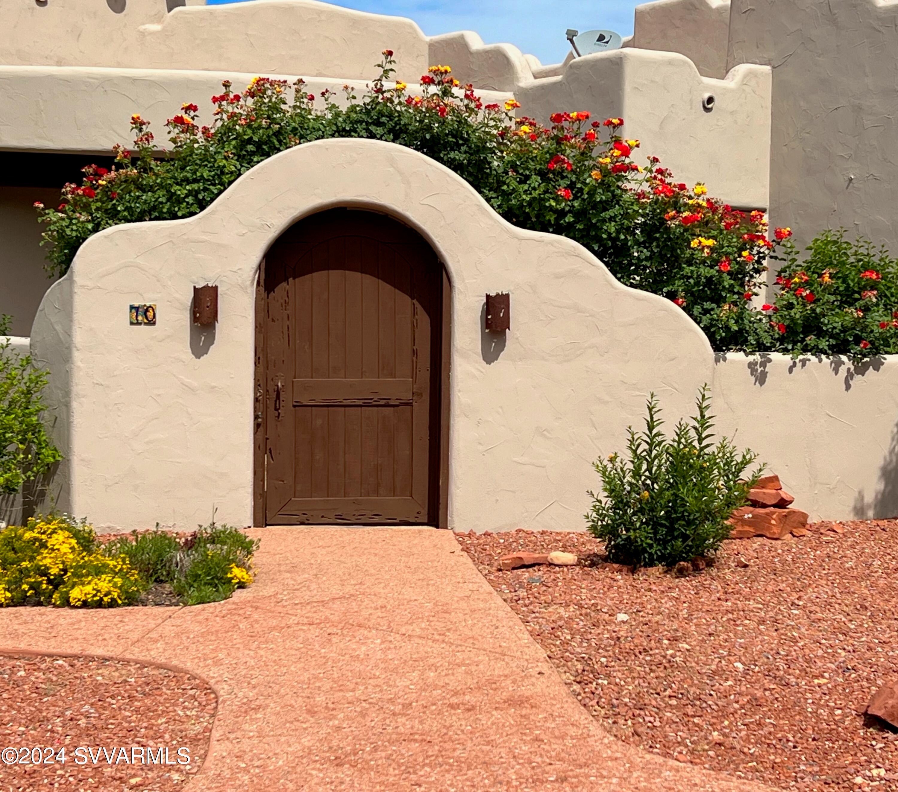 Striking red Rock views from main rooms in a home with character! Enter via a charming walled & enclosed courtyard with a waterfall, roses & grass.  A wall enclosed covered back patio is designed for entertaining with easy accessed from kitchen breakfast nook, dining or great room. A new chef's kitchen has a stainless side-by-side fridge, double oven, gas 6 burner cooktop, solid granite counters over new cabinets with extensive pull-outs. Central vac. makes cleanups a breeze! Primary suite has patio, resort style bath w/ marble walk-in shower + tub. Guest suite has it's own balcony! Large .41 acre lot on curve is private on all sides with top views. A beautiful community pool to enjoy plus the luxury of living in the red rocks outside the high tourist traffic areas of Sedona! New Roof by Hahn in 2020. New $24,000 HVAC system in 2020. Master bath remodel in 2020. Kitchen new in 2020 with 
all Electrolux Appliances.