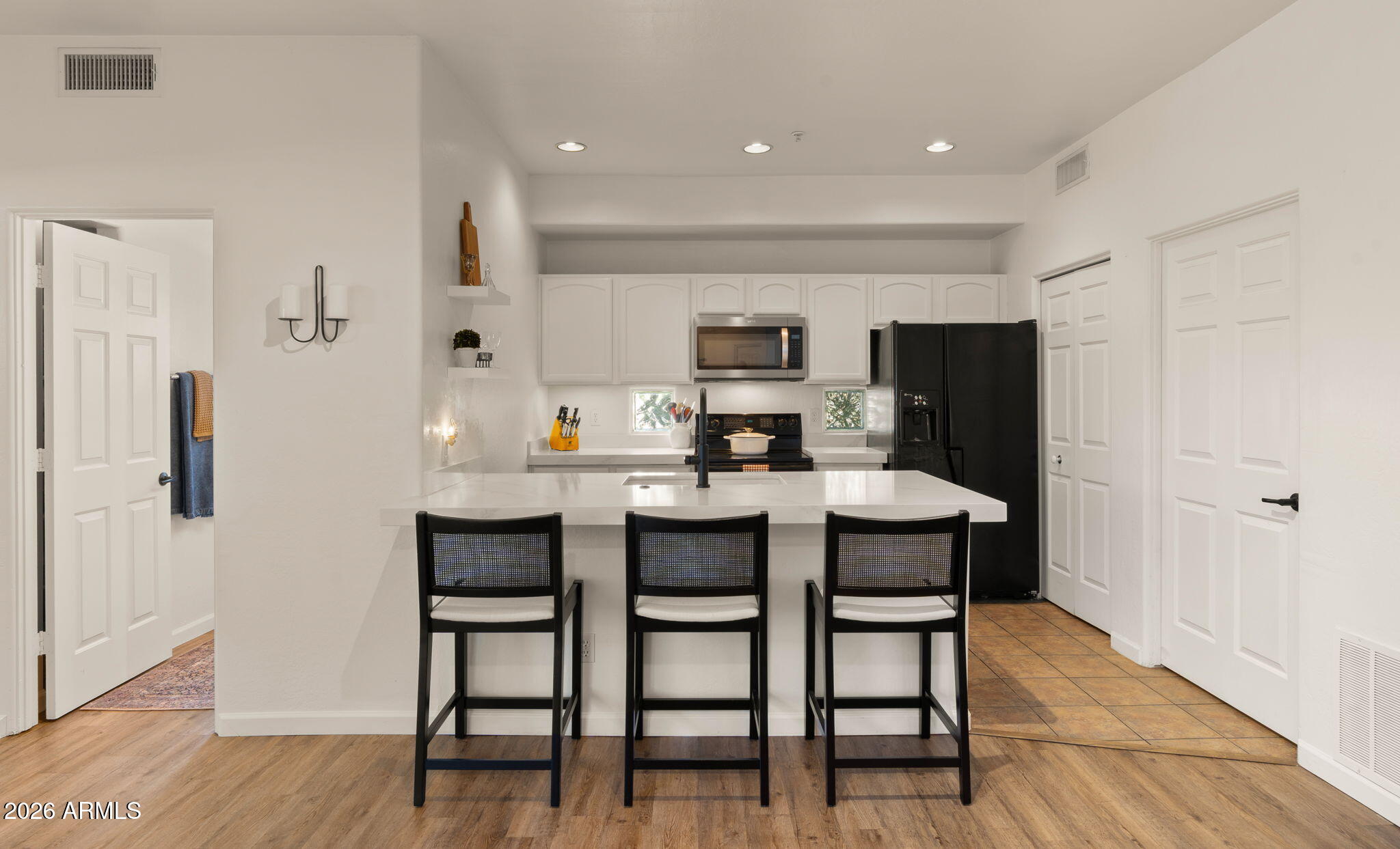 Premium Scottsdale location in the heart of it all! This 3 bed, 2 bath condo features a desirable split floorplan and a remodeled kitchen with thick quartz countertops, breakfast bar, and sleek cabinetry, opening to a spacious living area with a wood-burning fireplace. The large primary suite includes a walk-in closet and beautifully remodeled bath with dual vanities and a walk-in shower. The 3rd bedroom is perfect for a home office. Generous interior laundry room adds convenience. Enjoy your private balcony overlooking the community pool and spa. Quiet, well-maintained community next to El Dorado Park, the Greenbelt, and golf courses. Just minutes to Old Town Scottsdale, Fashion Square, Spring Training at Scottsdale Stadium, ASU, and Sky Harbor. The perfect first home or lock-and-leave!