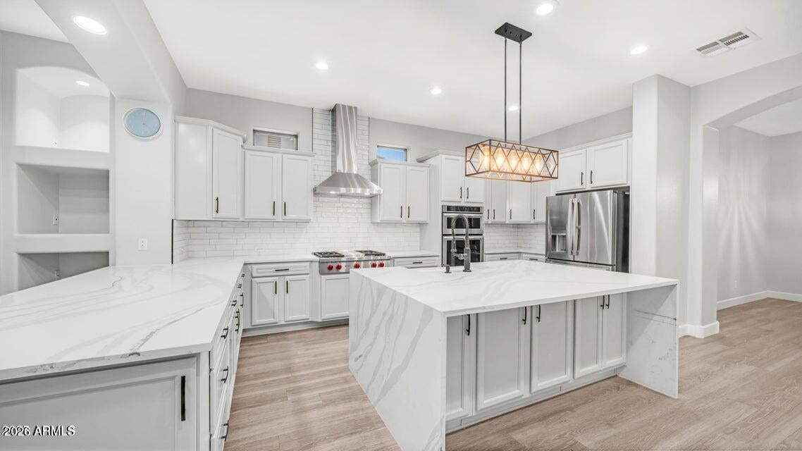 Looking for the best of the best in Goodyear without a million dollar price tag? Gated community, on a cul-de-sac, pool, outdoor BBQ, putting green, right next to a park and playground. Let's start in the kitchen with Quartz waterfall countertops, Wolf gas cooktop, GE Profile appliances, upgraded light fixtures, and military grade range hood. Large kitchen island. Vinyl plank flooring throughout the home. Wood shutters throughout.  Tons of recessed lighting, cozy courtyard with a gas fireplace, gas fireplace in family room. 3 car garage, 4 bedrooms, 3.5 baths, 1 guest room has its own bath with a mother in law jetted bath/shower combo, all bathrooms have quartz countertops. Please see the pictures and you will fall in love with this home. Great location, close to I-10, 303, 101
