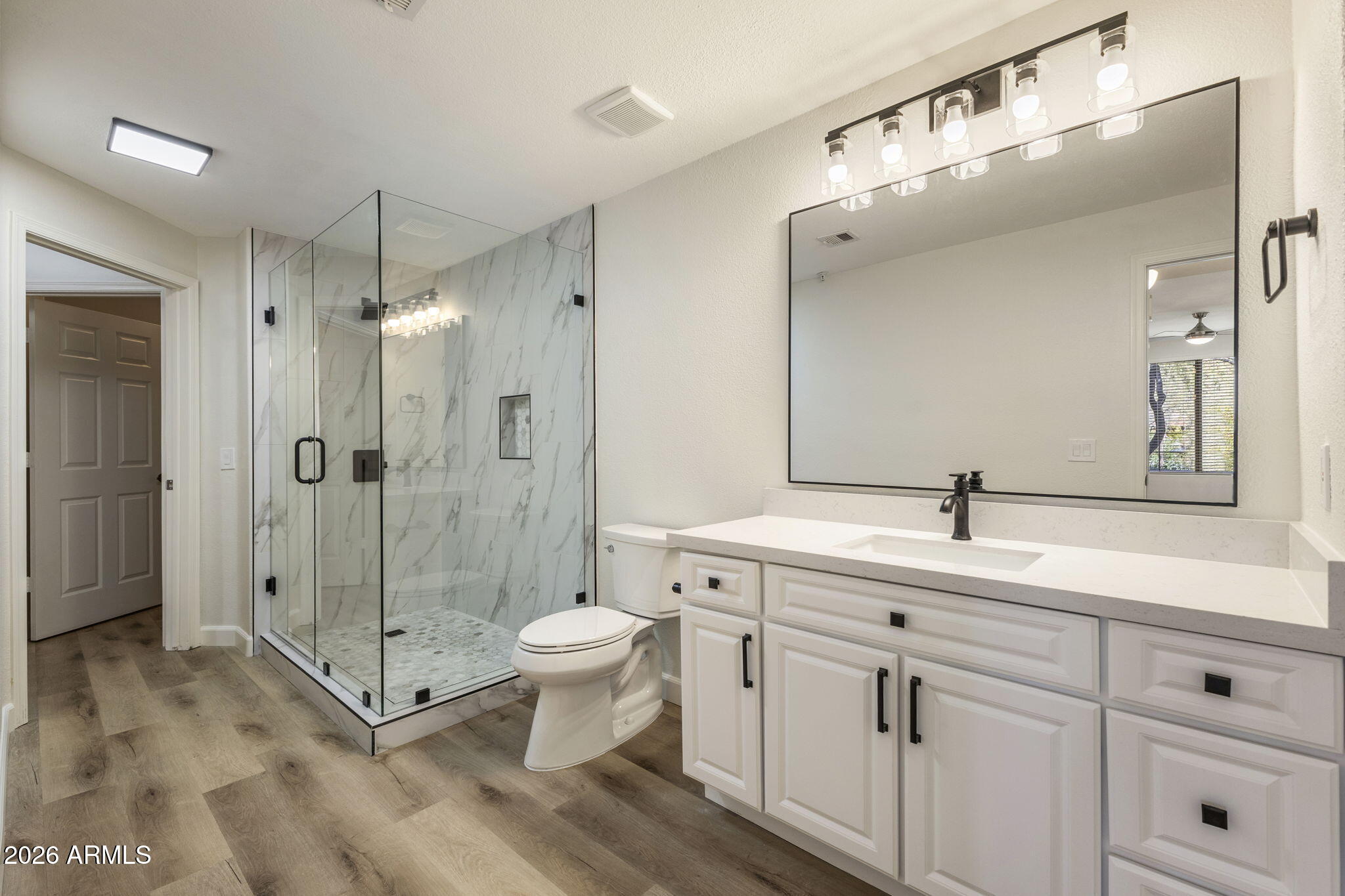 This stunning low maintenance condo is nestled in the heart of the vibrant Village at Market Street in DC Ranch in North Scottsdale. A full remodel of this beautifully appointed condo was just completed and offers 1 bedroom, 1 bathroom AND a dedicated office space. Inside, you will find a warm and inviting interior with new wood look flooring, new lighting & fixtures and paint in warm desert tones, soaring 9-foot ceilings & generous storage throughout.
The gorgeous & spacious kitchen is designed for both style & function, featuring new quartz countertops, a breakfast bar, refreshed cabinetry, LED lighting & a full suite of stainless steel appliances.  The dedicated office area is the perfect addition to this space & also has been refreshed with quartz countertops & new lighting. The bedroom is spacious and the attached bath offers luxury and the feeling of being in your own spa complete with glass and quartz finishes. This bath has been remodeled as well and features a new frameless glass shower, quartz countertops, undermount sinks, new lighting, mirrors, flooring and toilet.
The full inside laundry room features a full-size washer and dryer, along with an attached storage closet for all your needs and extra items.
One of the greatest highlights of this home is its unbeatable proximity to DC Ranch Market Street, just steps away. Here you will find an exceptional selection of restaurants, charming cafés, boutique shopping, and convenient everyday services, all within walking distance.
Residents of DC Ranch also enjoy exclusive access to pools, fitness facilities, scenic walking paths, and neighborhood parks, making this a truly low maintenance and highly desirable North Scottsdale living experience.