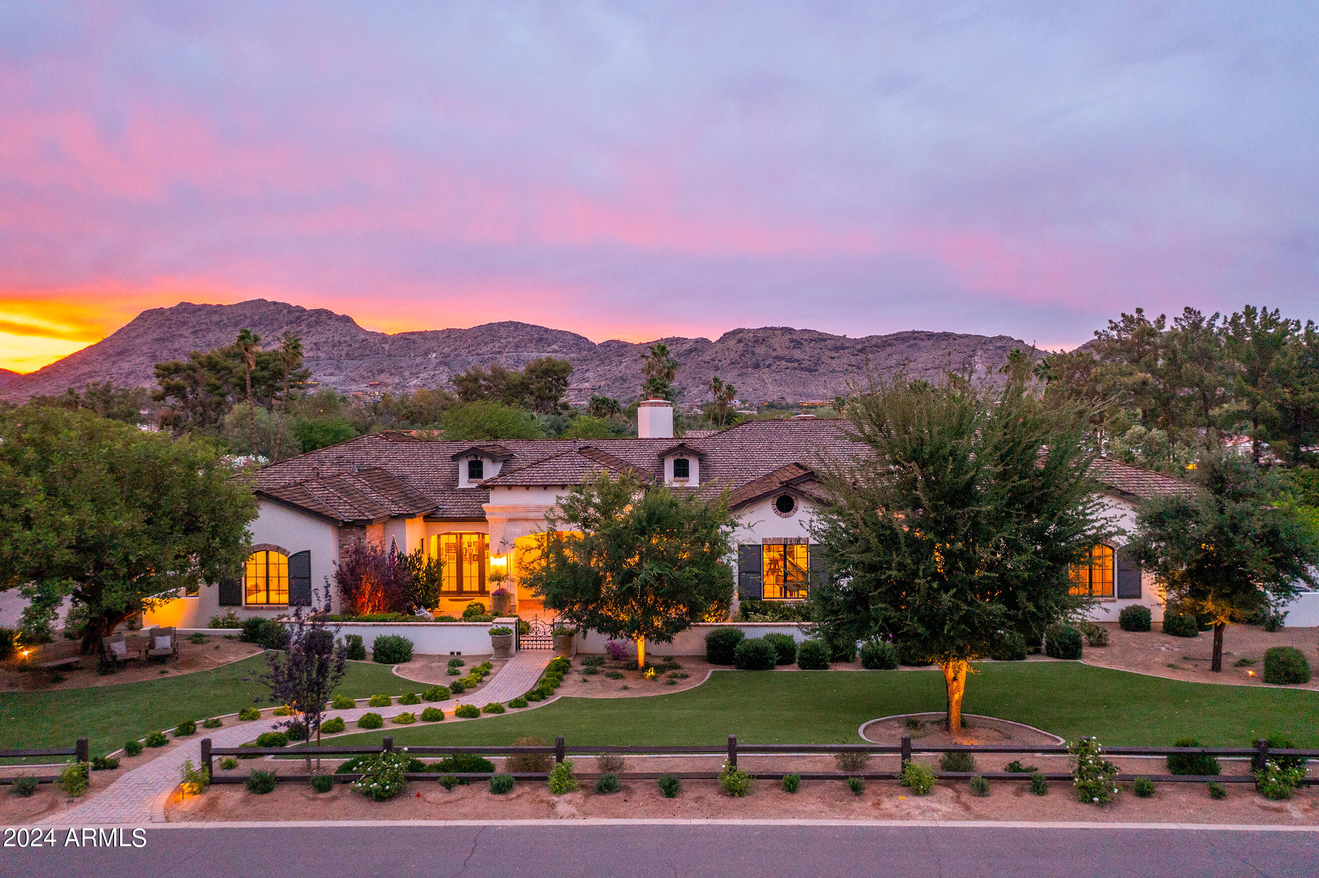 Welcome to your dream home in Paradise Valley on a sprawling 1.088 acres! Built in 2015, this elegant French Country home built by Santa Catalina Homes offers an exquisite blend of comfort and sophistication. Located in the heart of town with views of Camelback & Mummy Mountain. Open Floorplan with a Chef's kitchen featuring La Cornue gas range, Subzero fridge, Fisher Paykel dishwashers, large walk-in panty for all the storage one needs to entertain. Boasting 4 bedrooms/4.5 bathrooms and a spacious den/office , this home provides ample space for relaxation and productivity. Step into the resort-style backyard, complete with a large lap pool, spa, putting green, BBQ grill, patio heater and fireplace creating the perfect setting for year round entertaining. See supplement for more.... 4 car oversized and extended height garage with lift potential and a temperature controlled storage room. With ample space for a guest house, this estate presents exceptional opportunity to indulge in luxurious living in timeless Paradise Valley.