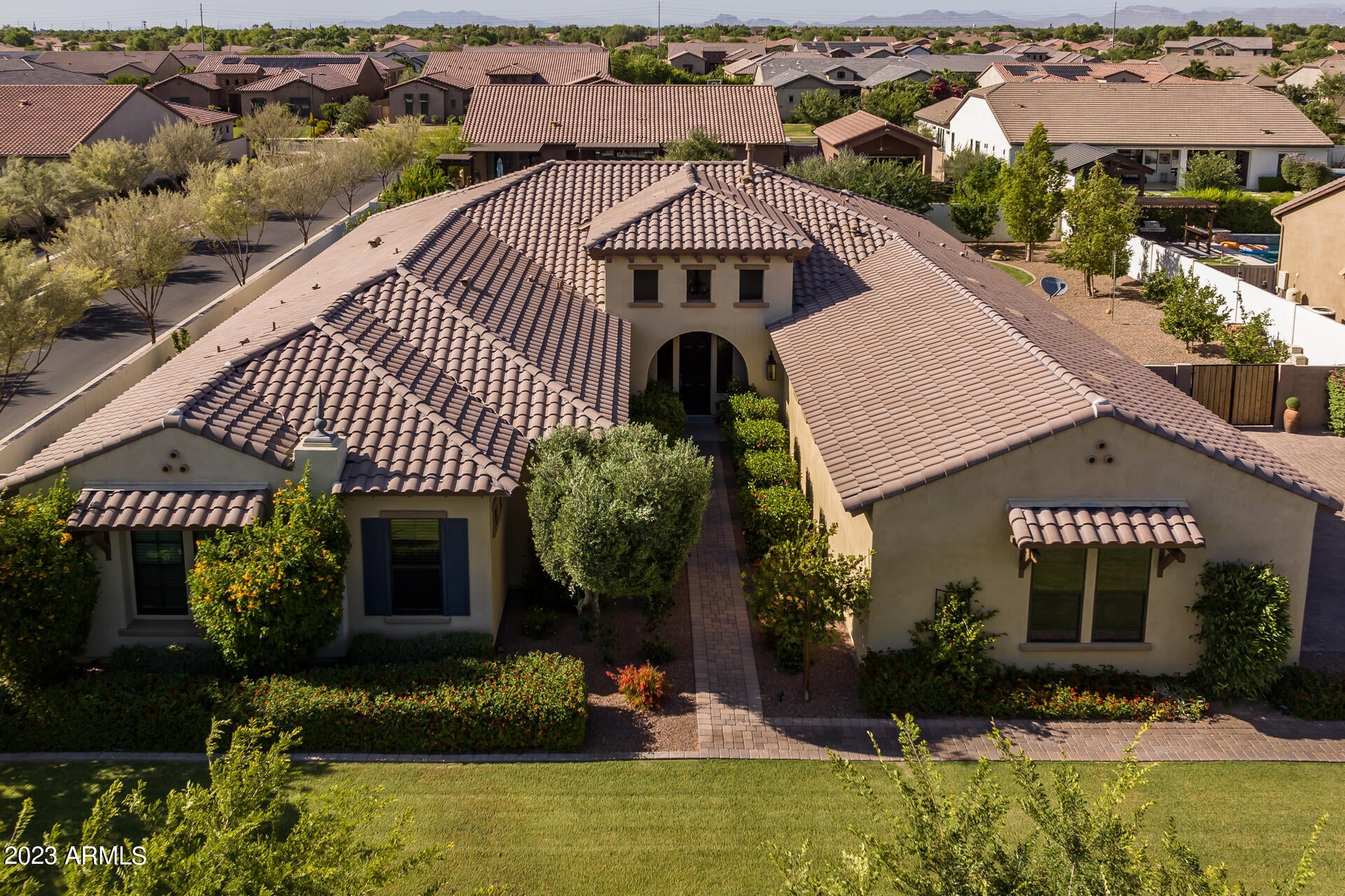 Welcome to this stunning home nestled behind the gates of Dorada Estates. This home sits on a premium corner lot, spanning over 20,000 square feet with a resort-style backyard! This Toll Brothers home is the Costellana model boasting an open great room layout, 5 bedrooms, 4.5 bathrooms, and a 4-car garage. As you step inside you will appreciate the flawless designer touches thoughtfully placed throughout the home. The open great room is an inviting space featuring a striking lighting fixture, a cozy built-in fireplace, and a multi-panel glass door that effortlessly connects the interior to the relaxing backyard. Through the custom glass double doors, you will find 2 separate bonus rooms that would be perfect for a sitting room, dining room, an office, or a playroom! The kitchen is luxurious, boasting a gourmet layout with cabinets that reach up to the ceiling, beautiful Quartz countertops, tile backsplash, a custom built-in Thermador refrigerator, stainless steel wall/gas appliances, and a kitchen island with pendant lighting. The primary suite is a serene haven, adorned with a stunning light fixture, a tray ceiling, and an artfully designed accent wall. The spa-like ensuite bathroom is a retreat, featuring a deep soaking tub, a dual sink vanity, a dual-headed tiled shower, and a generously sized walk-in closet. The remaining bedrooms are split from the primary suite with two of these bedrooms featuring walk-in closets and private ensuite bathrooms. The front bedroom is oversized and would make an amazing mother-in-law set up!  The other bedrooms share a jack-and-jill ensuite, ensuring all bedrooms have access to a bathroom. The laundry room boasts plenty of storage options with upper and lower cabinets and is completed with a convenient sink. The backyard is a private sanctuary offering a resort-style pool with a tranquil water fountain. A large, covered patio, complete with two ceiling fans, extends the living space outdoors, making it an ideal spot for entertaining guests! Do not miss out on this stunning home!
 
Dorada Estates is a gated community in a prime Queen Creek location, close to hiking, golf courses, dining, and shopping.