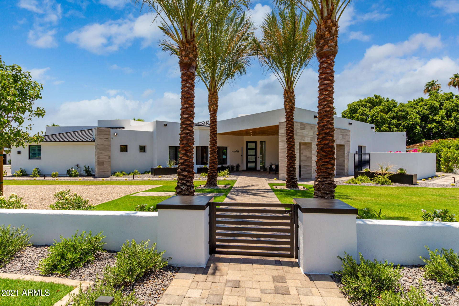 Newport coastal modern meets NY chic in this light bright soaring ceiling complete remodel by Arcadia Custom Builders. Reglet baseboards, custom flat panel cabinets, glass backsplash, LightForm lighting, Studio 41 plumbing fixtures, custom wine room by Heritage Wine, no expense spared! 6 bed split floorplan with large master suite and office on separate wing. Privately gated property allows for wonderful grass play space in the front yard capturing soaring views of Camelback. Full sport court and lots of covered patios complete with misters for a full resort vibe backyard experience. Minutes from the Valley's best shops, restaurants, Phoenician Resort, Waterfront and Old Town. Exeter is the most desirable street in Arcadia proper. Take advantage of summer heat to be in for the school year!
