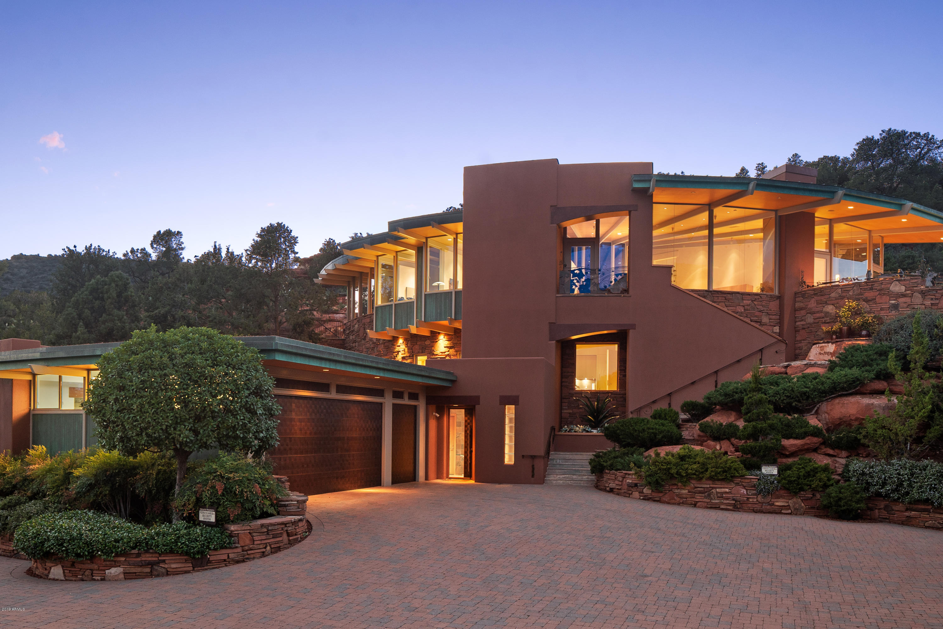 This exquisite contemporary designed home in Sedona offers unparalleled red rock views, quality construction, and beautifully executed architectural design. Three beautiful living structures with approximately 6,370 SqFt (the main residence, guest house, and pool cabana) are situated on 1.96-acres overlooking the signature hole on Oak Creek Country Club Golf Course, national forest and red rock formations. Four (4) bedrooms; seven (7) baths; a gourmet kitchen; home movie theater; office for two; laundry; two master suites; guest house with kitchen; and pool cabana. Home built in 2007, with $11.5 Million cost. State of the art security; smart home system from your iPad/iPhone. Guest House: 1157 SqFt. Pool Cabana: 477 SqFt. MAIN RESIDENCE - Main Living Level Accessed By Commercial Elevator Or 3 Separate Stairwells

* Great Room: Wall To Wall Northeast Red Rock Views That Come To Life As The Sun Moves To The West; Custom Copper And Steel Gas Fireplace That Is A Work Of Art; Granite And Custom Wood Buffet Table With Glass Faced Stemware Steel Cabinet; Surround Sound; Wall-Mounted TV's Included.

* Gourmet Open Kitchen: Appliances Have Never Been Used: Gas Gaggenau Cook-Top; Electric Gaggenau Cooktop; Gaggenau Deep Fryer; Gaggenau Steamer; Gaggenau Oven; Viking Warming Drawer Fisher And Paykel Kosher Dishwashers; Oven; Built-In Microwave; Custom Cabinetry; Granite Island; 3/4" Glass Top Breakfast Bar

* Master Bedroom (Split Floor Plan): Venetian And Crushed Glass Wall As You Enter Master; Patio With Sculpture; Second Patio With Master Suite Private Entry Onto Heated Spa With Spillover; Walk-In Closet; Wall Of Windows Exposing Red Rock And National Forest Views; Custom Bed With Drawers And Built-In Nightstands; Glass Art Sculpture On Wall With A Butterfly Shadowing Effect On The Wall; Electric Blinds

* Master Bathroom: Vanity Walk-In Jetted Shower With A Flowering Bouquet Of Tiled Wall Art; Bench Seating In Shower; Jetted Therapeutic Bathtub For Two; Custom Cabinetry; Upscale Toto Bidet In The Water Closet

* Second Master Suite & Bathroom: Private Patio With Moving Sculpture; Luxe King And Queen Round Bed; Walk-In Custom Closet; Wall-Mounted TV; ¾ Master Bath With Jetted Shower Heads

* Office: With Apple Computer + Built-In Desks For Two With Two Granite And Custom Wood Desks; Cabinetry; Views Of The Oak Creek Golf Course And Beautiful Mesa Buttes

* Laundry Room: KitchenAid 4.5 Ft Front Load Washer And Dryers; Wall Mounted Tv; Custom Cabinetry With An Abundance Of Storage; Wash Basin Sink; Built-In Ironing Board

* Powder Room: Cured Back-Lit Crushed Glass Over Venetian Plaster Wall; Glass Vessel Sink

* Radiant In-Floor Heating Main House - Natural Gas
* Wall-Mounted Tv's & Apple Computers
* Heated Spa (Natural Gas Hot Tub)
* Cascading Water Feature
* Partial Metal Roof With Steel Beams Across Ceiling
* Venetian Plastered Walls
* Wooden Ceilings & Wooden Floor To Ceiling Walls
* Surround Sound
* Alarms; Security; iPad In Every Room For Controls (Smart Home System)
* Natural Stone Flooring

MAIN RESIDENCE - 2ND FLOOR
* Home Theater System: Projector & Media Equipment; Apple Computer

* Kitchenette: With Subzero Refrigerator & Freezer; Custom Cabinets; Dining Area With Table And Chairs

* Guest Suite Bedroom: Built-In Hand-Crafted Custom Closets; Electric Blinds; Tv

* Guest 3/4 Bath With Walk-In Shower
* Room Furnace, Electronics For Media
* Spiral Stairwell With Contemporary Lighted Glass Steps
* Venetian Plastered Walls
* Surround Sound
* Outdoor Patio For Guest Suite

MAIN RESIDENCE - 1ST FLOOR
* Garage: 3-Car Or Two Car + Golf Cart Access Into Main Residence + Storage Cabinets & Workbench
* Commercial Elevator: Temperature Controlled Elevator Equipment Room With Split HVAC (3 Floors).
* Bathroom (1/4 Bath)
* Security Door: Front Door Woven Copper Panels

Guest House Second Building Overlooking Golf Course
* One-Car Garage [Over-Sized] + Storage
* Office Desk + Apple Computer; Wall Mounted Tv; Abundance Of Built In Custom Cabinetry In Living Area With Convex And Concave Wall Accents
* Kitchen Appliances: Gaggenau Electric Stove - 2 Burner; Subzero Refrigerator & Freezer Drawers; Fisher & Paykel Dishwasher; Hand Cut Stone Flooring; Soddalite Granite Counters
* Heat Pump HVAC
* Gas Fireplace With Granite Facing & Hearth
* Guest Bedroom With TV: Granite; Built-In Custom Cabinetry; Two Queen Beds Fit Comfortably
* Bathroom (3/4 Bath) With Single Vanity; Glass Sink With Undermount Lighting; Granite Matching Master Bedroom; Makeup Vanity; Water Closet; Walk-In Pharo Jet Stream Shower + Floor To Celing Granite In Shower
* Alarm & Security Cameras On Exterior
* Surround Sound

POOL CABANA
* Commercial Steel Kitchen: Refrigerator/Chilling Drawers/Ice-Maker; Dishwasher; Microwave; Indoor Electric Grill
* Bath (3/4 Bath) Includes Steam Shower
* Smart Home System
* Surround Sound
* Alarm & Security Cameras On Exterior
* Heat Pump HVAC
* Pool Gas Heating


EXTERIOR
* Pool
* Heated Spa With Ambiance Of Endless Water Spillover Faced With Artistic Sculpture
* Cascading Water Feature
* Security Cameras, Including A Security Camera At The Gated Entry - All Monitored
* Custom Artistic Iron Electronic Gate
* Perimeter Areas Fenced With Hand-Crafted Sculptured Iron Fencing
*Limestone Decks, Steps
* Numerous Art Sculptures Placed Into The Exquisite Landscaped Design
* Drip System For All Landscaping: Including Landscaping Into National Forest To Prevent Fire Hazards (Landscapers Scheduled Weekly On Tuesdays)
* Hand Crafted Patina Faux Copper Around Roof-Lines
* Custom Stone Floors: Granite In Main Residence; Limestone With Fossils; Exterior Limestone

SUPPLEMENTAL INFO
* Living Room Single Pane Star-Fire Glass (Blue Glass) Ordered From Ny - Commercial Grade
* Steel & Masonry Construction + 4 Concrete Deck Pan
* Full Synergy System & Heavy Mesh (Synthetic Stucco)
* Walls Have 2" Thich Foam Insulation
* Commercial Hydraulic Elevator
* Each House Has Its Own Breaker Panels
* Three (3) Phase
* All Water Heaters Natural Gas
* Taxes: $16,981 - 2019 Includes Both Parcels: 405-28-015b &405-28-015e

UTILITIES:
* ELECTRIC: APS
* GAS: Unisource
* WATER: Big Park
* SEPTIC: Conventional Septic
* TRASH: No Trash Pickup
* PHONE; INTERNET; CABLE: CenturyLink
* TV: Direct TV Previously Installed (Not Hooked Up)
* ALARM; SECURITY; ELECTRONICS: Desert Sounds

--------------------------------------------------------------------------

* 1.96 Acres (2 Parcels Included With Sale: 405-28-015e & 405-28-015b). Seller Did Not Combine Parcels For Property Tax Advantages. Purchased Parcels In 2000/2001: Built In 2007 Completed (5 Years)
* 6,370 Square Feet (Builder) Includes Main Residence, Guest House, Pool Cabana (Sqft Does Not Include Garages). County Records (Taxes Paid) On: Main Residence: 4,488 Sqft; Guest House: 1,157 Sqft; Pool Cabana House (477 Sqft)
* Situated Against National Forest