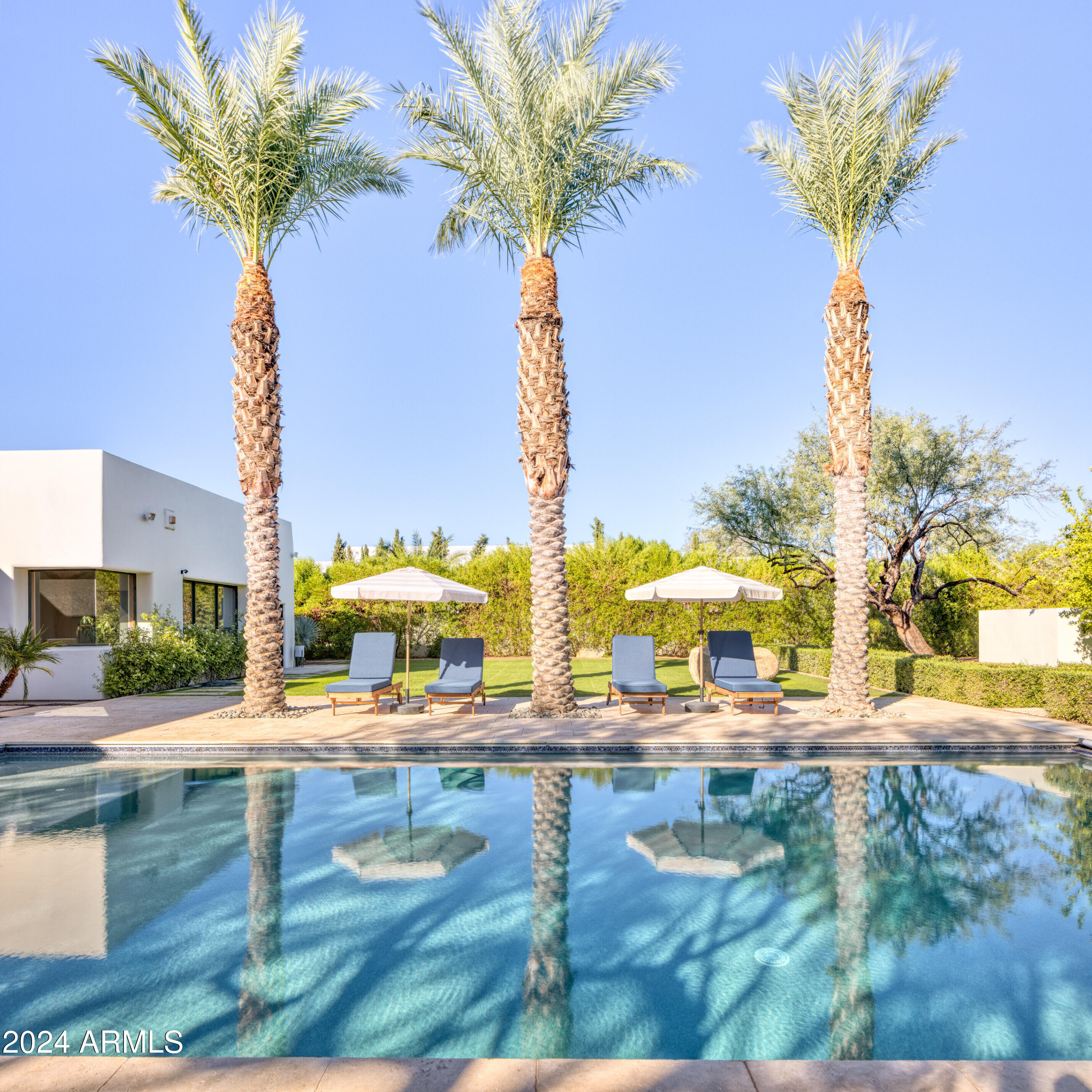 This recently renovated, charming 4 bed, 4 bath, 4,650 sq ft  home boasts a huge backyard.  Mature sculptured mesquite trees, including one with a children's treehouse, + citrus grove separate the very large grass yard + heated pool from a private pickleball/sports court. The modern interior features white oak floors, exposed brick walls, + contemporary wood accents. The chef's kitchen opens to a great rm + patio w/ BBQ, fireplace, TV + an outdoor shower nearby. A versatile large flex rm can be a game rm, fitness space or fifth bedrm. There is also a glass wine wall, attached guest casita + a cozy office . The home was completely gutted in 2020 with new kitchen, auxiliary bathrms + additional construction.In 2024 oak floors were installed and a new primary bathrm.  3 C'S SCHOOL DISTRICT! There is beautiful detail in the curved folded plaster wall which sits about 8 inches just beneath the clay tile roof.

Citrus trees:    Key lime, mandarin orange, naval orange, Lisbon lemon, Oro Blanco Grapefruit