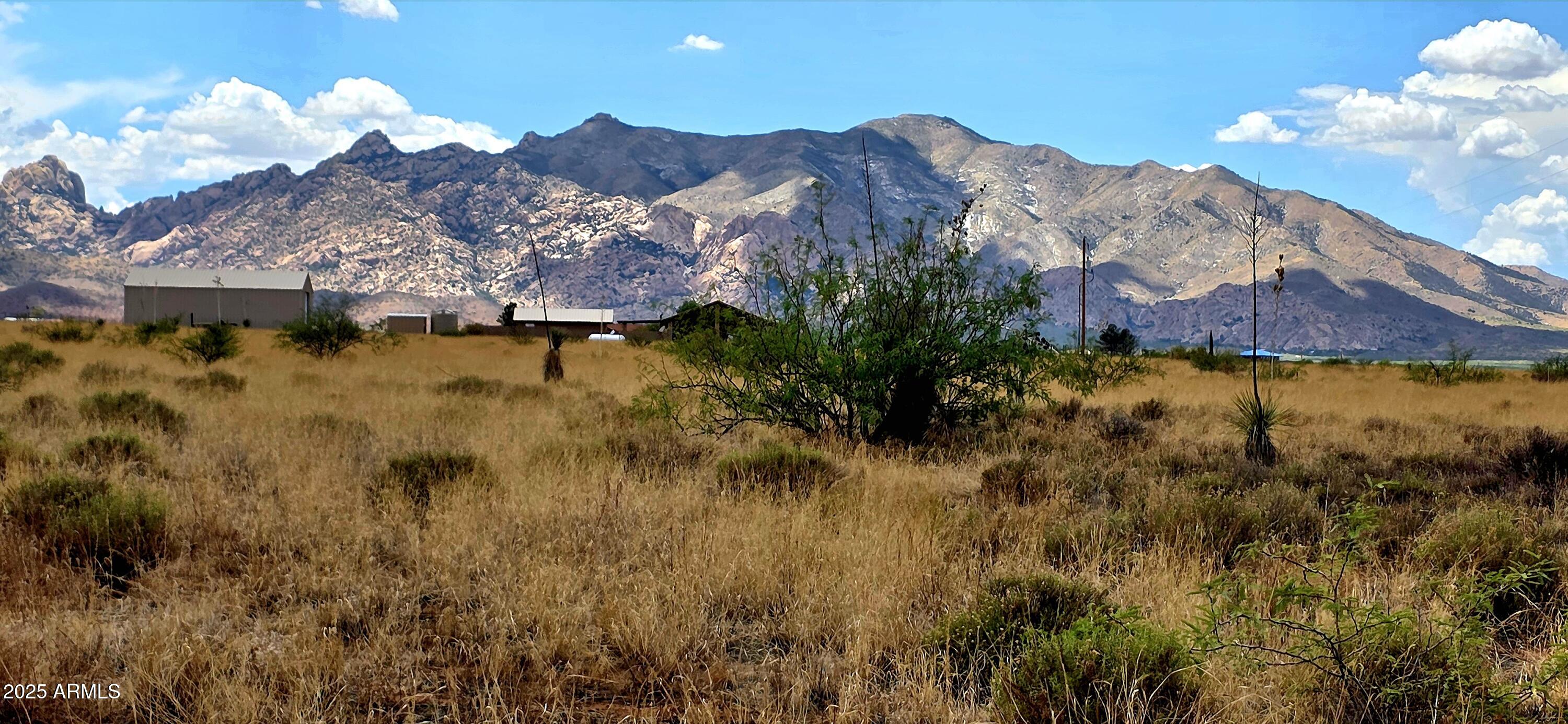 083 acres in a quiet, rural residential neighborhood.  A corner lot, the land is level and the mountain views are spectacular! Electric is at property line. If more land is desired, the contiguous parcel #116-11-166, .827 acres is also for sale. Perfect for your site built home. Buyer to verify all facts and figures.