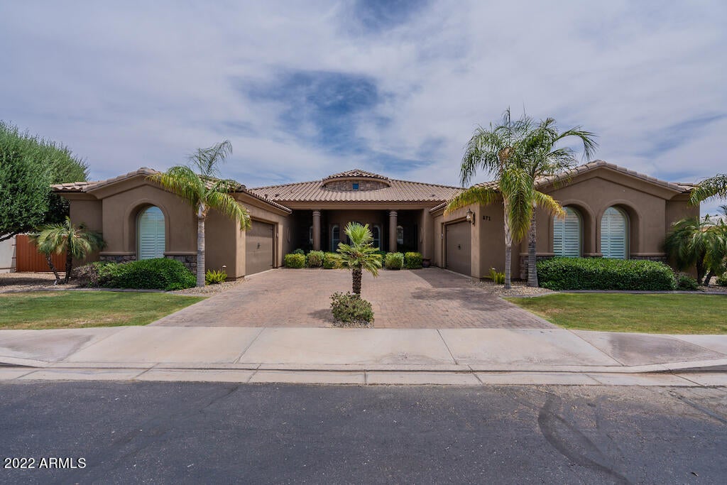 Located in a gated enclave of 40 single-level homes, this beautiful custom features striking architectural details, elevated finishes & RARE dual 2-car garages. The dramatic arched entry leads into the great room with a custom, lighted entertainment wall & wine bar. The kitchen includes a 6-burner gas range, large island with veg sink, smart-touch faucets, expansive breakfast bar, under-cabinet lights & walk-in pantry. A bonus/game room with home theatre pre-wire opens to the private, resort-style backyard with travertine patio, heated pool & spa, firepit, and BBQ. You'll appreciate the expansive windows, interior gas fireplaces, whole-home sound system, shutters, 12-foot ceilings, stone bathrooms and flooring, cabinets galore, central vac pre-plumb, soft water, Chandler schools and more! See interior floor plan in Photos and Documents tab.