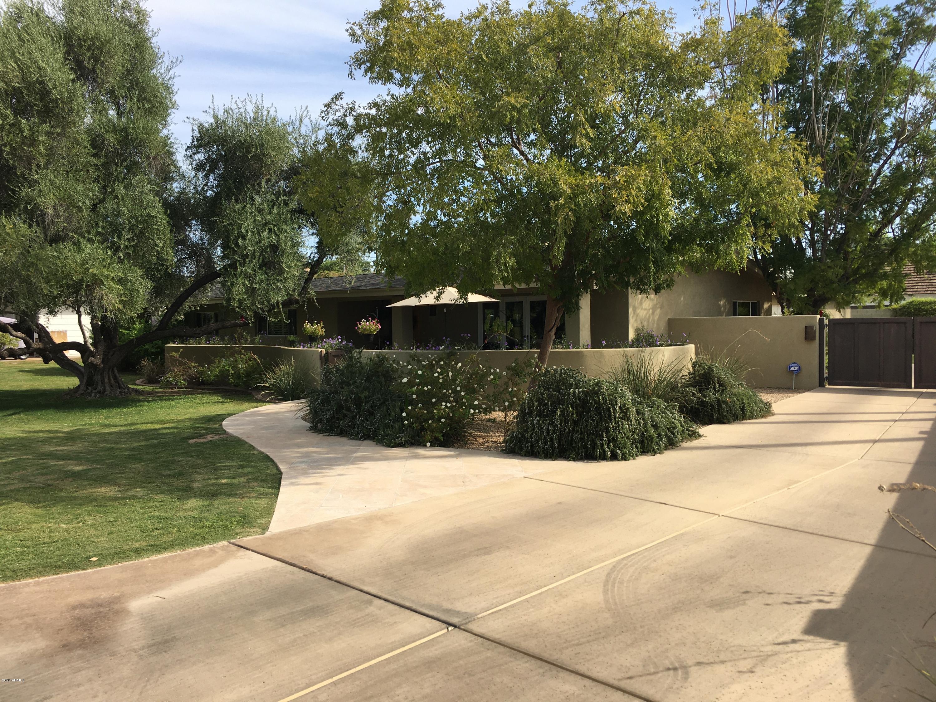 This incredible ranch style home is nestled right in the heart of Arcadia w/ spectacular views of Camelback Mountain. Recently remodeled w/ exquisite finishes from floor to ceiling including gorgeous wood flooring and custom cabinetry. Open concept w/ a split floor plan includes a large master suite, 3 spacious bedrooms and a separate office/playroom/workout room. Spectacular gourmet kitchen will satisfy even the most discerning Chef w/ gas range, Dacor double wall ovens, & an abundance of storage. Entertain family & friends in this resort style backyard that features sparkling pool, putting green, outdoor kitchen & spacious patio to enjoy the beautiful mountain views.