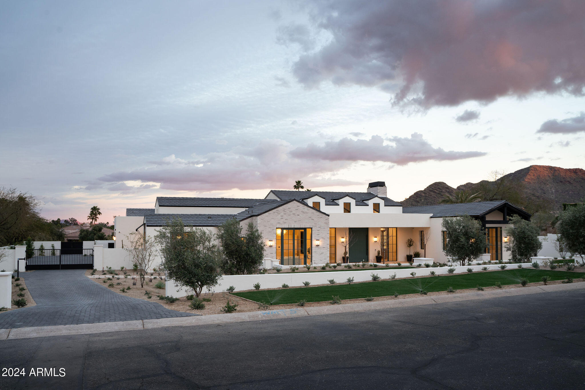 Experience the epitome of modern luxury living in this 5 bedroom 6.5 bath new build. Unveil the charm of its architecture as you step into a captivating family room with a seamlessly disappearing door, effortlessly merging indoor and outdoor spaces. The kitchen is a masterpiece with a thoughtfully designed layout,custom cabinetry,and exquisite marble counters,complemented by top-tier Wolf and Sub-Zero appliancesA richly appointed butler's pantry adds a touch of sophistication.Discover generously designed en suite bedrooms, each a haven of comfort,and an exceptional office space with a private entrance.The wellness/exercise room caters to your needs, providing ample space for fitness.The opulent owner's suite boasts a custom marble fireplace,private patio,his and hers closets and a luxurious bath. Step outside to a meticulous, richly landscaped oasis, complete with a sparkling pool and spa featuring LED lighting and deck jets. The outdoor kitchen promises the ultimate culinary and entertainment experience. Home automation takes center stage with Lutron lighting, Luma security, an HVAC air filtration system, and prewiring for electric car charging. Indulge in the finest details of modern luxury living in this exquisite home. Designed  by PHX architecture, built by Paramount Luxury Development and Sapanaro Development, landscaping by Berghoff Designs and Interior Design by Smythhouse