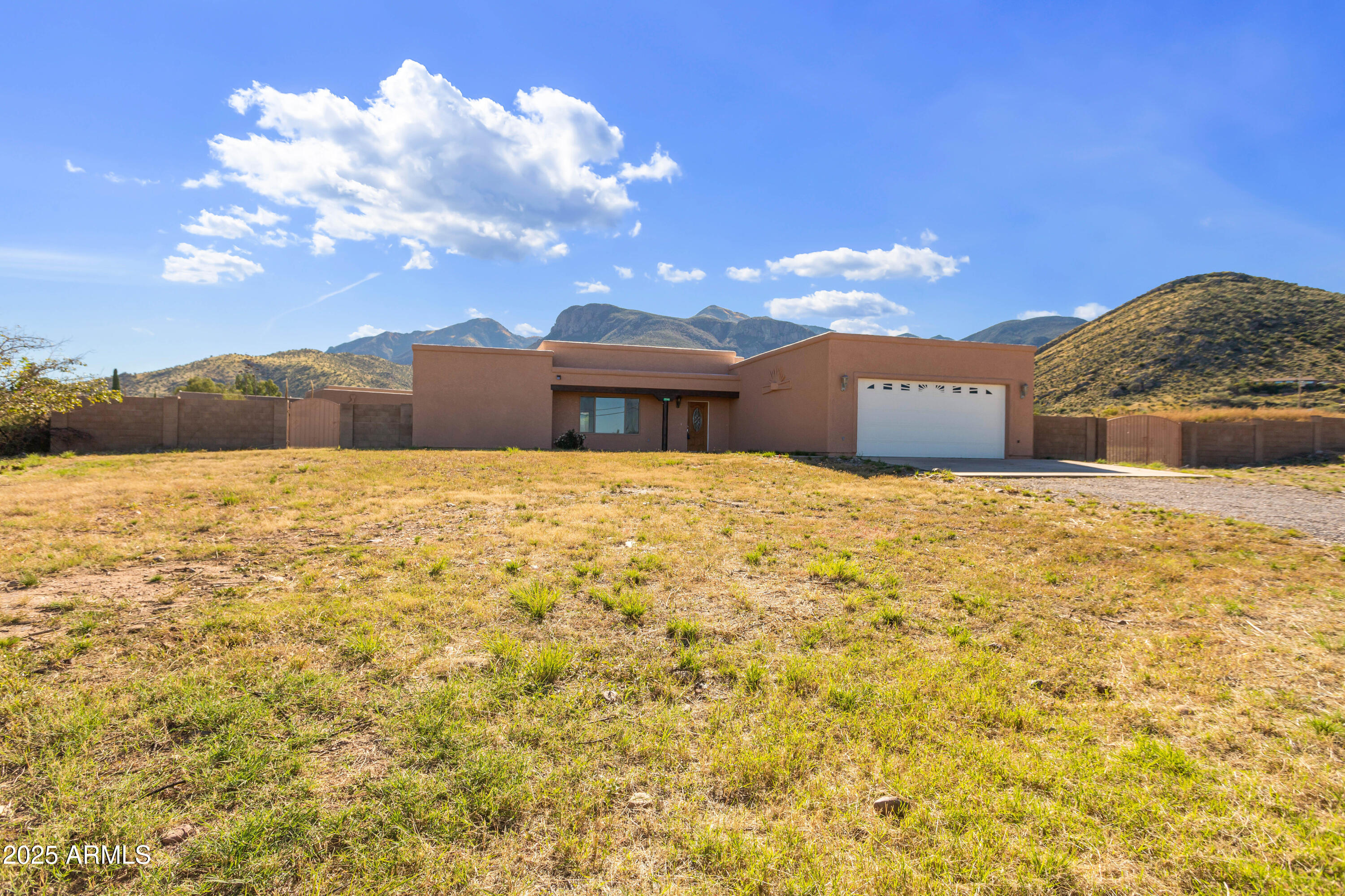 No HOA! Home is Remodeled, Beautiful Country Living!!! Enjoy this gorgeous 4 BDRM, 2 BATH,  2.5 car garage home w/ 0.83 acre block fenced back yard & waterfall views!!! Open floor plan w/a large kitchen & lots of storage. 4 large bedrooms, primary bath has step-in shower, guest bath with large garden tub.  Gorgeous tile floors and vinyl plank floors through out!!  Many ceiling fans.  oversized 2.5 car garage can accommodate your full-size truck and all of the tools. Freshly painted inside & outside. RV parking is available in the secured block fenced back yard.  Enjoy breath-taking mountain views from the covered patio!!! Frige, washer & dryer stay (As-Is). ON PAVED ROAD. Horses OK. Easy access, home is in turn-key condition!!!  Make sure home is secured, lights off when leaving.