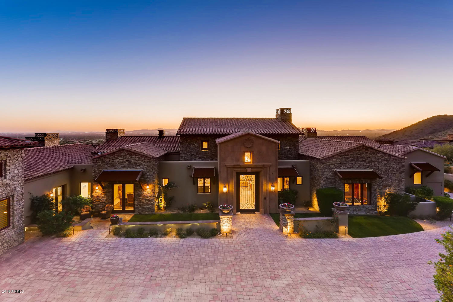 Absolutely exquisite executive home nestled high against McDowell Mountain in the lovely community of Ancala. From the privately gated driveway, wind up the hill past the stunning waterfall feature to this beautifully appointed single level home, displaying the best of finishes tastefully chosen by the builder. Designed by world renowned architect Erik Peterson, this home sits on arguably the highest and best estate lot in Ancala-3.58 acres-featuring unobstructed expansive views of Camelback Mountain. Relax in the 50 foot negative edge pool, spa, or any of the stunning outdoor seating areas. Notice the natural stone accents, extensive use of authentic stacked rock, and lovely landscaping.  Floor  to ceiling retractable sliding doors ,  2 massive marble fireplaces, simply amazing. The gourmet kitchen has all the features the discerning cook would expect: Wolff gas stove, Sub-Zero refrigerator,  retractable hibachi grill in massive island, two dishwashers. Master bedroom is lovely with second of two marble fireplaces, outside access to patio and spa. Huge master bath with lavish finishes--two huge separate closets, separate sinks, separate closeted commodes. All secondary bedrooms are en suite. Additional amenities include theater room, office with fireplace,plaster ceilings and stunning chandelier in entryway, wet bar with zinc countertops and wine refrigerator. Did I mention the fabulous man cave with fireplace, golf simulator, and two garages with room for 8+ cars? Guest house is currently used as a large gym, with sink, refrigerator, and bathroom. Interior design by Danielle Jacques Design. This home is unique, with too many extras to list. All located in Ancala, featuring private golf course, tennis, heated pool and spa, trails.