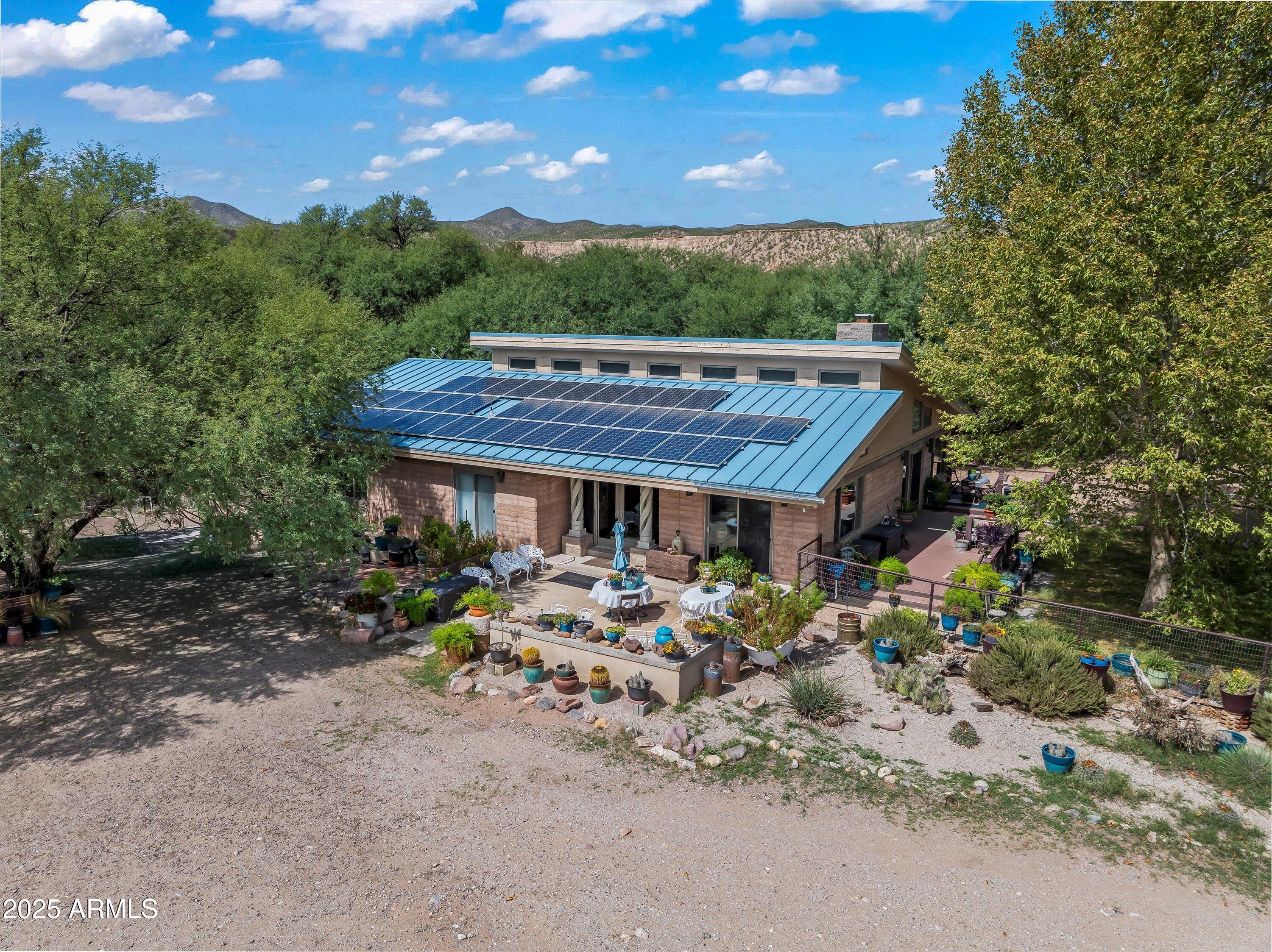 Escape to Your Own Paradise in Benson, Arizona-- A Dream Property for Ranchers, Farmers, Horse Lovers or Retirees! Set along the San Pedro River that offers the freedom and functionality every landowner dreams of. This 254-acre Arizona ranch for sale offers unmatched privacy and endless potential. Perfect for expanding your ranch or farm, growing your agriculture business, building an equestrian/livestock/farming facilities, creating a premier hunting or tourist retreat, or establishing a quiet Western haven perfect for retirees seeking space and serenity. Whether you're a rancher, farmer, horse owner, or retiree seeking peaceful rural property in Benson, AZ, this wide-open acreage offers the freedom to live the lifestyle your way. LAND & WATER:
50+ irrigated pastures - irrigation well pumps 800 - 1000 gallons a minute
Two domestic wells
1 livestock well
1 septic tank
Spring-fed pond ideal for fish, waterfowl, & wildlife
Fencing: Welded pipe and mesh surrounding the headquarters and irrigated pastures.
Combination of electricity and solar panels

RESIDENCES:
2,400 sqft rammed earth main home
Open floor plan with 360-degree view of the property, large stone fireplace, commercial kitchen w/pantries, Arizona room, 2bed/2bath, and more
1,200 sqft straw bale ranch home
Covered with historic Tombstone Rose, with a fireplace in the living space, 2bed/1bath, and more
Studio apartment or office & large storage space
Multiple carport structures for vehicles or equipment

EQUESTRIAN & LIVESTOCK INFRASTRUCTURE:
Two barns with 19 stalls to accommodate any type of breeding program
Working corrals & round pen
Tack & feed rooms
Covered hay & equipment storage
Squeeze chute for livestock
Pastures designed for isolation, breeding, and disease prevention

LIFESTYLE & RECREATION:
Adjacent to the International Bird Sanctuary
360° mountain and desert views
Home to rare and migratory species, perfect for bird watching
Hiking, fishing, horseback riding, and wildlife observation
Unique desert flora including rare blooming cactus
Located in a development-protected area no neighbors, no noise, no pollution.

LOCATION:
22 miles from Benson, AZ including 12 miles scenic unpaved road or with access to Cascabel Highway. A peaceful drive through Arizona's untouched high desert landscape sets the stage for the tranquility and beauty that awaits.

This is Arizona's desert gem a one-of-a-kind oasis hideaway surrounded by natural beauty. Don't miss this rare opportunity to own one of Southern Arizona's most unique and versatile properties.