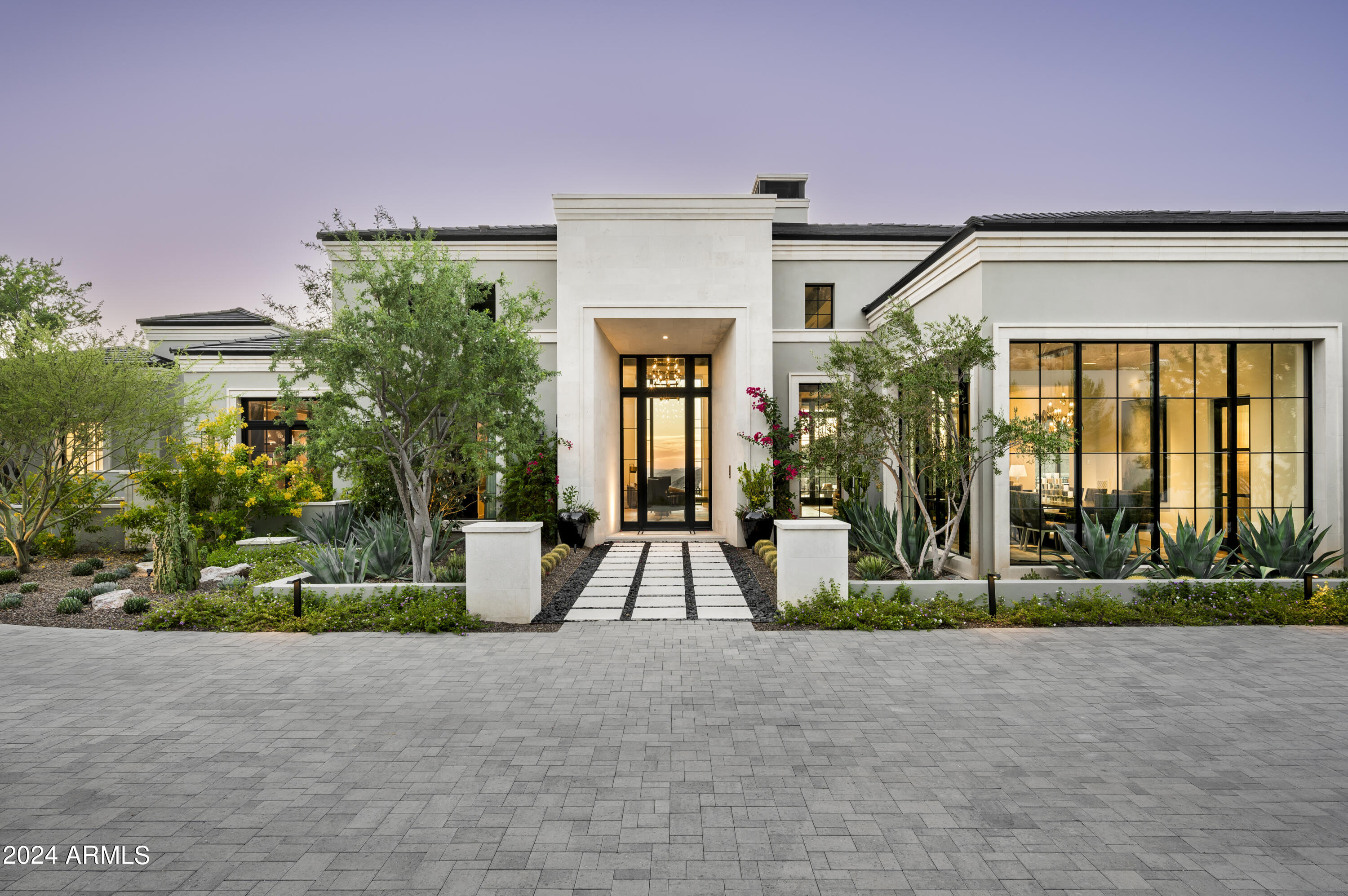 This newly built Modern Mediterranean Estate has been uniquely crafted and perfectly designed to offer the ultimate luxury lifestyle.  Nestled on nearly two acres in the prestigious Silverleaf Community and surrounded by uninterrupted panoramic city view- this home perfectly encapsulates everything to be a top- notch entertainment destination. The expert design of this Modern Mediterranean residence was a collaborative effort between Erik Peterson of PHX Architecture, interior designer Laura Kehoe, and custom builder Ted Reisdorf of Paragon Custom Homes. Built with the finest materials by top artisans in the valley, every detail exudes luxury. The grand great room seamlessly opens to the stunning outdoor space for the finest indoor/ outdoor living- made for the ultimate enjoyment of the perfect Arizona evenings. Accompanied by a gourmet kitchen with a separate catering kitchen, casual and formal dining areas, and an additional butler's pantry this home does not miss a single detail. The entertainment hub is thoughtfully designed, featuring a nightclub-inspired bar, billiards area, lounges, multi-game simulator, wine room, and a theater that seats 19. The private office leads to the opulent 2,000 sq ft owner's suite, complete with a sitting area, wet bar, and breathtaking city and mountain views. The suite boasts three custom-designed, boutique-style closets with private laundry, and a spa-like bathroom with dual vanities, a makeup station, a steam shower with multiple heads, and a soaking tub. The bathroom also has access to a private garden with a hot tub overlooking the valley. Guests will enjoy luxurious accommodations in the three full guest suites with their own family room or one of the two guest casitas. Offering a true luxury indoor-outdoor lifestyle, the entertaining spaces extend seamlessly to the multi-level outdoor areas, providing incredible views of mountains, sunsets, and city lights from every angle. The main level boasts a resort-style infinite pool, multiple sun-soaked and shaded patios, an outdoor kitchen, a lush grassy lawn, and two separate hot tubs- perfect for a lifestyle of relaxation and entertainment. Silverleaf is an exclusive, guard-gated community distinguished by its tree-lined streets, private parks, and some of the most exclusive homes in Arizona. At its heart lies the renowned Silverleaf Club, featuring a par-72 golf course designed by Tom Weiskopf, a stunning clubhouse, a luxurious spa, and an array of amenities that offer the ultimate desert resort lifestyle