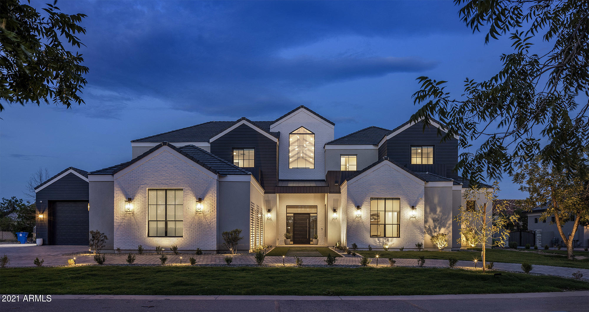 This gorgeous custom home by premier builder Riverwood Development is nestled in Queen Creek's The Pecans gated community complete with tree-lined streets that transport you to a place that contrasts the desert landscape of the east valley. Upon entering the home you are shocked by the grand vaulted ceilings and exposed beams; however, the grandeur does not stop there. The home features a sauna, indoor gym, and movie room making it perfect for entertaining. The most notable feature is the amazing full half court hardwood indoor basketball court complete with the latest technological features, and disco lighting for the ultimate basketball game experience. Unique features like a hidden room with access to a balcony that overlooks the basketball court make this home truly special. The entire home is hardwired with Control 4 lighting, surround sound, and security.  Lights include dimmers in most areas, and can all be controlled on an app or mounted touchscreen.  The large kitchen with expert finishes and gorgeous cabinetry is an extension to the family room and great room and the open concept living allows for entertaining at its best. Butler pantry features a prep sink, nugget ice maker, and tech center for the kids.  No expense has been spared on the soon to be completed backyard pool area with jump platform, waterslide, and grotto, spa, covered ramada area, and fire pit.