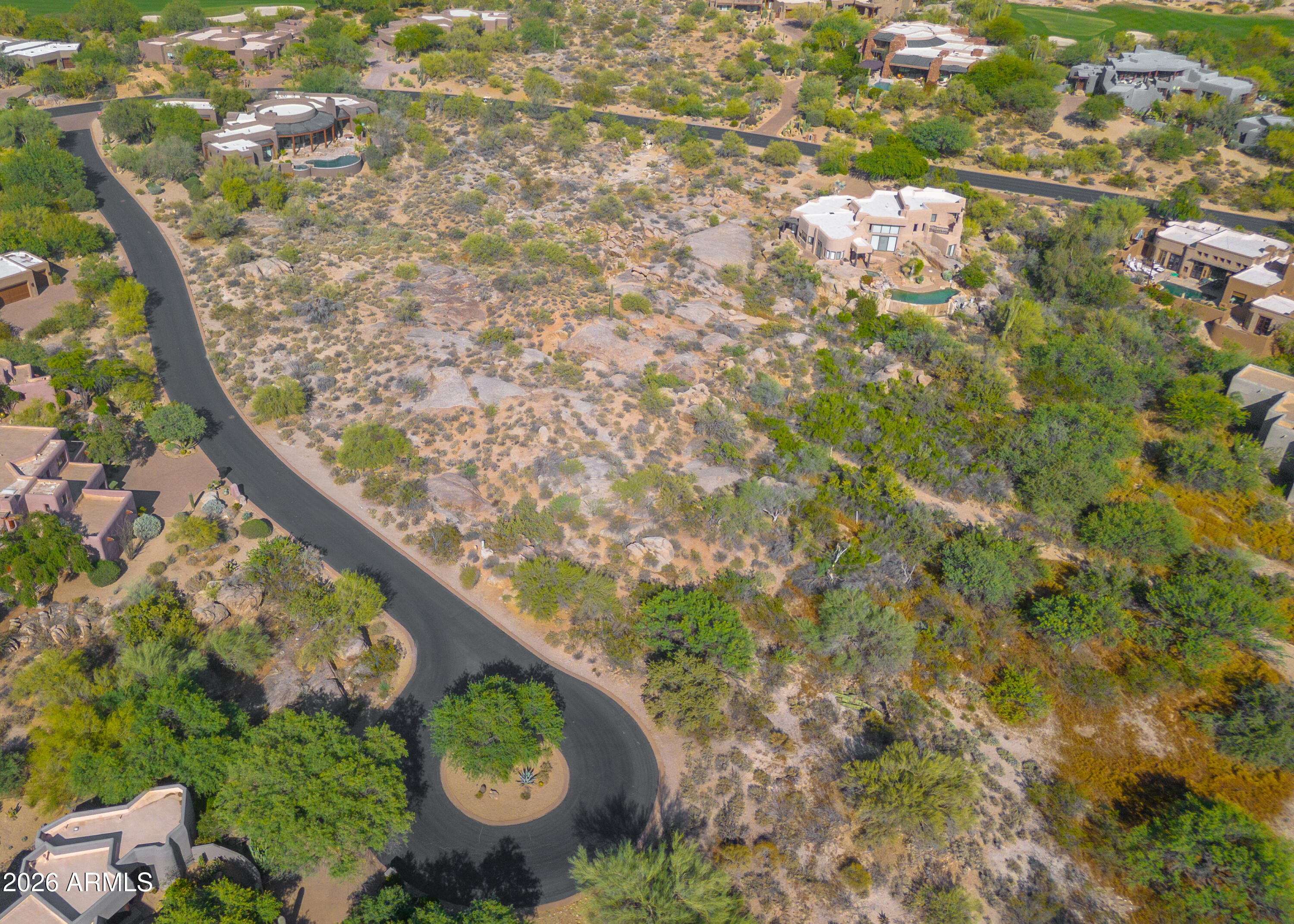 WOW!  A rare find! 1.3 acre cul-de-sac lot w/ stunning VIEWS of the Boulders, Black Mtn & Spectacular AZ SUNSETS. Private, elevated setting w/ generous building envelope nestled among lush Sonoran Desert vegetation of saguaros & mature native trees. Homesites in The Boulders are SCARCE: parcels of this size, privacy & views are even more limited, making this a standout opportunity for a custom build. Located in one of Scottsdale's most prestigious, world-renowned resort golf communities, lot is ideal for those seeking new construction in an established luxury setting. May access community pools. Optional membership available for championship golf courses, full service spa, fitness, tennis & pickleball, dining & more amenities. One of the last remaining build opportunities in this area.