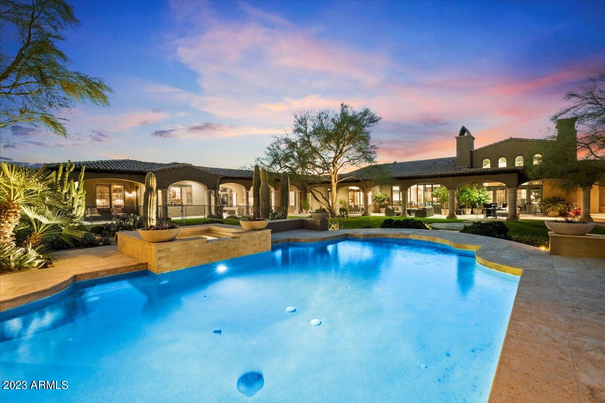 In the small exclusive gated Community of Prado Estates lies this exceptional residence. Set upon 4.3 acres guaranteeing privacy and peacefulness, the European architecture leads into a home of immense quality. Towering exposed beam ceilings, large stone fireplaces and tile floors define the interior styling. The reception foyer leads into a formal living room with pool views. the heart of the home includes the family room, kitchen and casual dining area complimented by a fully fitted bar and climate controlled wine room. The rear yard is a leisure rich experience with classic swimming pool with spa, tennis court and putting pitching greens. The detached 2 bedroom guest house is perfect for long staying visitors. In one of North Scottsdale's premiere locations this home exudes luxury.