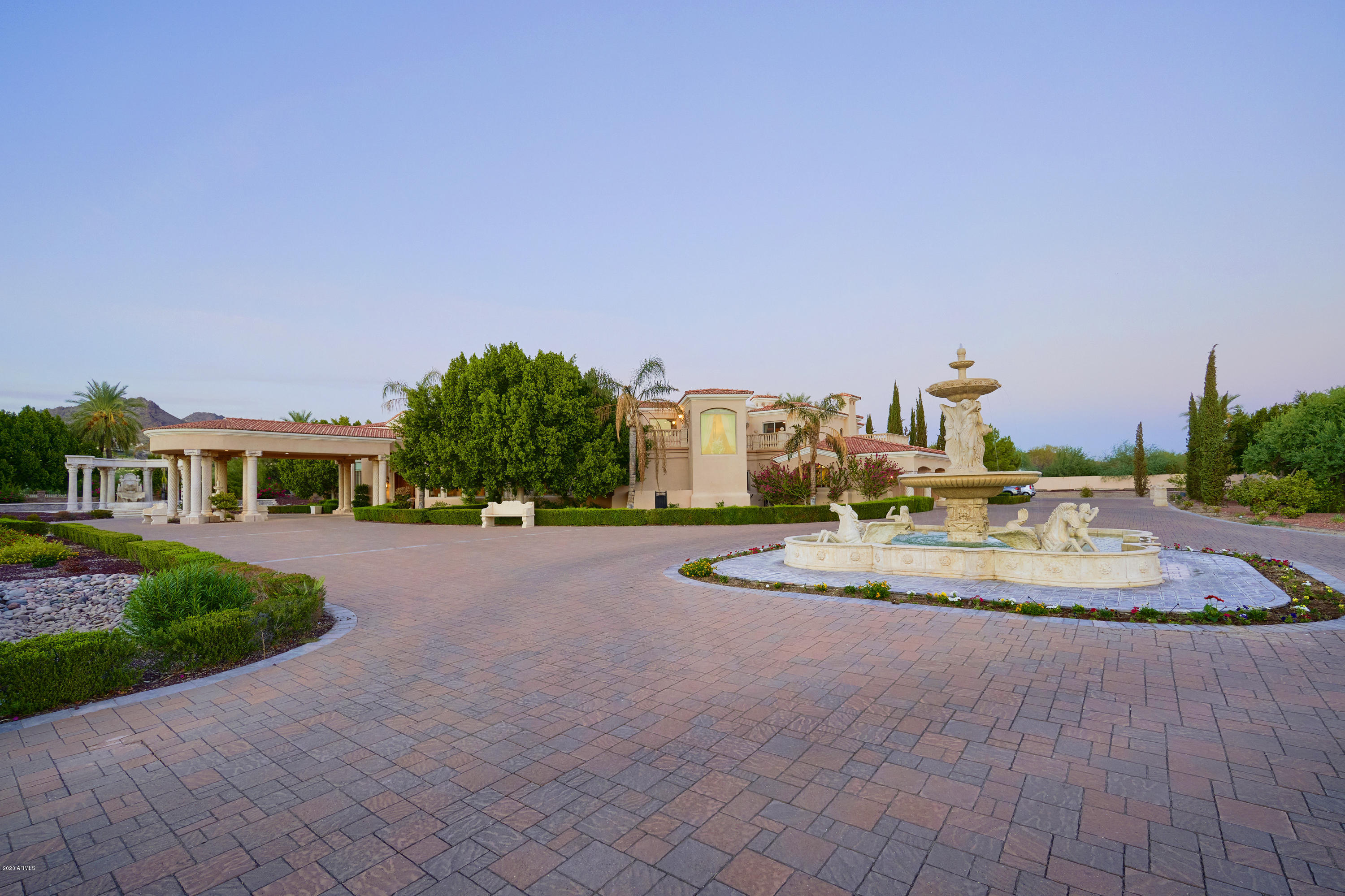 Spacious, Privately Gated, European Style Grounds on just over 3.5 acres. This Paradise Valley Estate views Camelback Mountain (Praying Monk) and the Squaw Peak. Its backyard offers Olympic size Pool/Spa, Bocce Ball Courts, putting green, sand volleyball, in ground Trampoline, kids play area, park-like grounds with 5 carved fountains, 2 fire pits, a fireplace, covered outdoor living and dining patio, guest home; benches throughout the landscaped, low voltage lighting and drip system. Indoors, enjoy custom inlaid polished Marble floors, limestone columns and Italian imported staircase makes it all welcoming. The home offers 5 fireplaces, an Exercise Room, Sauna in the Master suite, Executive Office, Theater Room, Butler's Pantry, Caterers Kitchen, Wet Bar with Ice mater, 600+ bottle stone-clad wine cave, 7 bedrooms, 9 baths, 8-Car Garages, room to build more and NO HOA. 15 min drive to PHX International, 5 min drive to Biltmore or Scottsdale Fashion Square. Walking distance to the iconic Hermosa Inn. See Motion Video under Photos