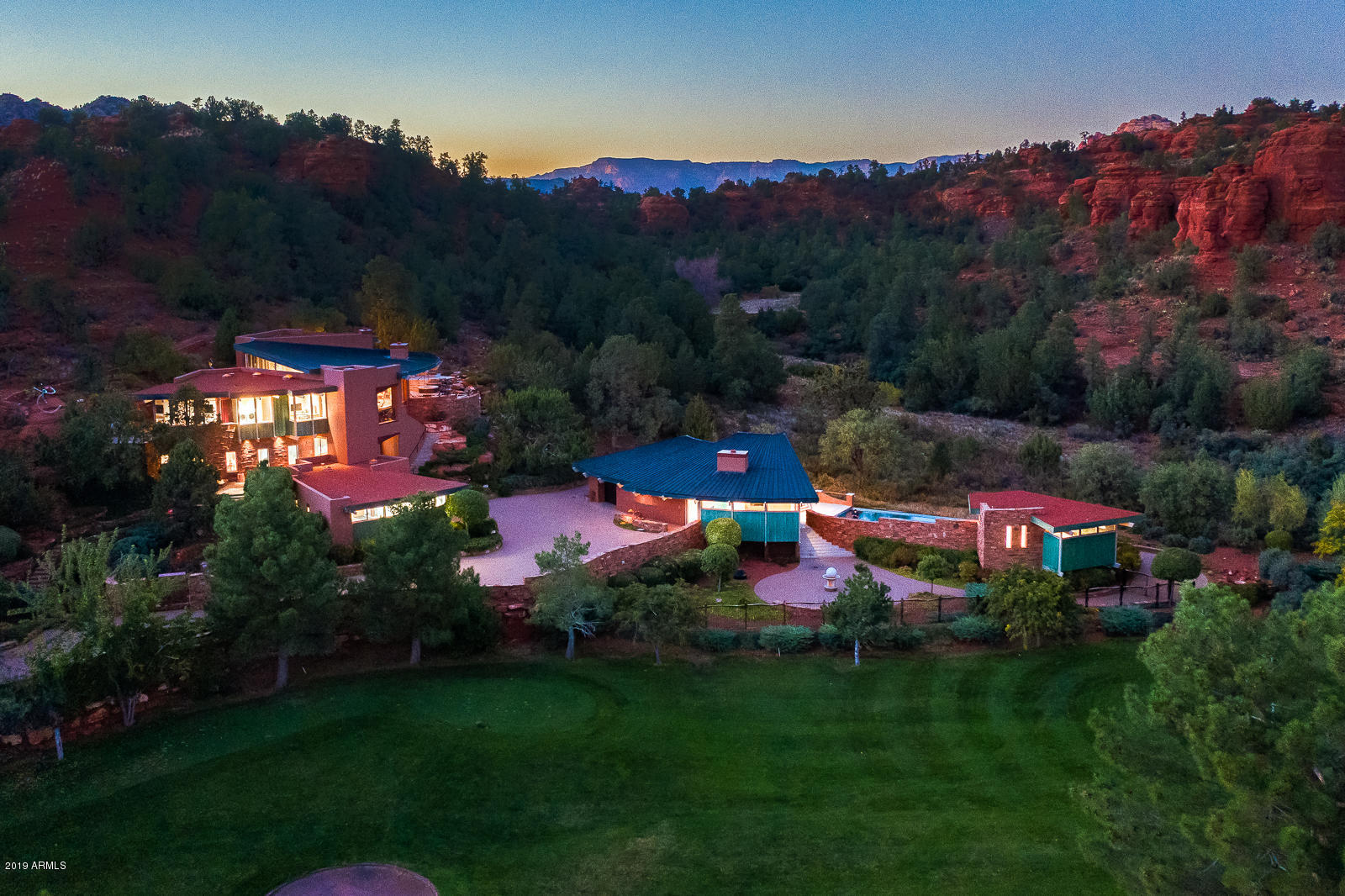 This exquisite contemporary designed home in Sedona offers unparalleled red rock views, quality construction, and beautifully executed architectural design. Three beautiful living structures with approximately 6,370 SqFt (the main residence, guest house, and pool cabana) are situated on 1.96-acres overlooking the signature hole on Oak Creek Country Club Golf Course, national forest and red rock formations. Four (4) bedrooms; seven (7) baths; a gourmet kitchen; home movie theater; office for two; laundry; two master suites; guest house with kitchen; and pool cabana. Home built in 2007, with $11.5 Million cost & Seller has not lived in the home. State of the art security; smart home system from your iPad/iPhone. *Contents negotiable. MAIN RESIDENCE - Main Living Level Accessed By Commercial Elevator Or 3 Separate Stairwells

* Great Room: Wall To Wall Northeast Red Rock Views That Come To Life As The Sun Moves To The West; Custom Copper And Steel Gas Fireplace That Is A Work Of Art; Granite And Custom Wood Buffet Table With Glass Faced Stemware Steel Cabinet; Surround Sound; Custom Designer Contemporary Furniture Never Used - Pieces Negotiable; Wall-Mounted TV

* Gourmet Open Kitchen: Appliances Have Never Been Used: Gas Gaggenau Cook-Top; Electric Gaggenau Cooktop; Gaggenau Deep Fryer; Gaggenau Steamer; Gaggenau Oven; Viking Warming Drawer Fisher And Paykel Kosher Dishwashers; Oven; Built-In Microwave; Custom Cabinetry; Granite Island; 3/4" Glass Top Breakfast Bar

* Master Bedroom (Split Floor Plan): Venetian And Crushed Glass Wall As You Enter Master; Patio With Sculpture; Second Patio With Master Suite Private Entry Onto Heated Spa With Spillover; Walk-In Closet; Wall Of Windows Exposing Red Rock And National Forest Views; Custom Bed With Drawers And Built-In Nightstands;  Glass Art Sculpture On Wall With A Butterfly Shadowing Effect On The Wall; Electric Blinds

* Master Bathroom: Vanity Walk-In Jetted Shower With A Flowering Bouquet Of Tiled Wall  Art; Bench Seating  In Shower; Jetted Therapeutic Bathtub For Two; Custom Cabinetry; Upscale Toto Bidet In The Water Closet

* Second Master Suite & Bathroom: Private Patio With Moving Sculpture; Luxe King And Queen Round Bed; Walk-In Custom Closet; Wall-Mounted TV; ¾ Master Bath With Jetted Shower Heads

* Office: With Apple Computer + Built-In Desks For Two With Two Granite And Custom Wood Desks; Cabinetry; Views Of The Oak Creek Golf Course And Beautiful Mesa Buttes

* Laundry Room: Kitchenaid 4.5 Ft Front Load Washer And Dryers; Wall Mounted Tv; Custom Cabinetry With An Abundance Of Storage; Wash Basin Sink; Built-In Ironing Board

* Powder Room:  Cured Back-Lit Crushed Glass Over Venetian Plaster Wall; Glass Vessel Sink

* Radiant In-Floor Heating Main House - Natural Gas
* Wall-Mounted Tv's & Apple Computers
* Heated Spa (Natural Gas Hot Tub)
* Cascading Water Feature
* Partial Metal Roof With Steel Beams Across Ceiling
* Venetian Plastered Walls 
* Wooden Ceilings & Wooden Floor To Ceiling Walls
* Surround Sound
* Alarms; Security; iPad In Every Room For Controls (Smart Home System)
* Natural Stone Flooring

MAIN RESIDENCE - 2ND FLOOR
* Home Theater System: Projector & Media Equipment; Apple Computer

* Kitchenette: With Subzero Refrigerator & Freezer; Custom Cabinets; Dining Area With Table And Chairs

* Guest Suite Bedroom:  Built-In Hand-Crafted Custom Closets; Electric Blinds; Tv

* Guest 3/4 Bath With Walk-In Shower
* Room Furnace, Electronics For Media 
* Spiral Stairwell With Contemporary Lighted Glass Steps
* Venetian Plastered Walls
* Surround Sound
* Outdoor Patio For Guest Suite

MAIN RESIDENCE - 1ST FLOOR
* Garage: 3-Car Or Two Car + Golf Cart Access Into Main Residence + Storage Cabinets & Workbench 
* Commercial Elevator:  Temperature Controlled Elevator Equipment Room With Split HVAC (3 Floors). 
* Bathroom (1/4 Bath) 
* Security Door: Front Door Woven Copper Panels 

Guest House   Second Building Overlooking Golf Course
* One-Car Garage [Over-Sized] + Storage 
* Office Desk + Apple Computer; Wall Mounted Tv; Abundance Of Built In Custom Cabinetry In Living Area With Convex And Concave Wall Accents
* Kitchen Appliances: Gaggenau Electric Stove - 2 Burner; Subzero Refrigerator & Freezer Drawers; Fisher & Paykel Dishwasher; Hand Cut Stone Flooring; Soddalite Granite Counters 
* Heat Pump HVAC
* Gas Fireplace With Granite Facing & Hearth
* Guest Bedroom With TV: Granite; Built-In Custom Cabinetry; Two Queen Beds Fit Comfortably
* Bathroom (3/4 Bath) With Single Vanity; Glass Sink With Undermount Lighting; Granite Matching Master Bedroom; Makeup Vanity; Water Closet; Walk-In Pharo Jet Stream Shower + Floor To Celing Granite In Shower
* Alarm & Security Cameras On Exterior
* Surround Sound

POOL CABANA
* Commercial Steel Kitchen: Refrigerator/Chilling Drawers/Ice-Maker; Dishwasher; Microwave; Indoor Electric Grill
* Bath (3/4 Bath) Includes Steam Shower 
* Smart Home System
* Surround Sound
* Alarm & Security Cameras On Exterior
* Heat Pump HVAC
* Pool   Gas Heating


EXTERIOR
* Pool 
* Heated Spa With Ambiance Of Endless Water Spillover Faced With Artistic Sculpture
* Cascading Water Feature
* Security Cameras, Including A Security Camera At The Gated Entry - All Monitored 
* Custom Artistic Iron Electronic Gate
* Perimater Areas Fenced With Hand-Crafted Sculptured Iron Fencing 
*Limestone Decks, Steps
* Numerous Art Sculptures Placed Into The Exquisite Landscaped Design 
* Drip System For All Landscaping: Including Landscaping Into National Forest To Prevent Fire Hazards (Landscapers Scheduled Weekly On Tuesdays)
* Hand Crafted Pantina Faux Copper Around Roof-Lines
* Custom Stone Floors: Granite In Main Residence; Limestone With Fossels; Exterior Limestone

SUPPLEMENTAL INFO
* Living Room Single Pane Star-Fire Glass (Blue Glass) Ordered From Ny - Commercial Grade
* Steel & Masonry Construction + 4 Concrete Deck Pan
* Full Synergy System & Heavy Mesh (Synthetic Stucco)
* Walls Have 2" Thich Foam Insullation
* Commercial Hydrolic Elevator
* Each House Has Its Own Breaker Panels
* Three (3) Phase
* All Water Heaters Natural Gas
* Taxes: $16,981 - 2019 Includes Both Parcels: 405-28-015b &405-28-015e

UTILITIES:
* ELECTRIC: APS
* GAS: Unisource
* WATER: Big Park
* SEPTIC: Conventional Septic
* TRASH: No Trash Pickup
* PHONE; INTERNET; CABLE: CenturyLink
* TV: Direct TV Previously Installed (Not Hooked Up)
* ALARM; SECURITY; ELECTRONICS: Desert Sounds

--------------------------------------------------------------------------

* 1.96 Acres (2 Parcels Included With Sale: 405-28-015e & 405-28-015b). Seller Did Not Combine Parcels For Property Tax Advantages. Purchased Parcels In 2000/2001: Built In 2007 Completed (5 Years)
* 6,370 Square Feet (Builder) Includes Main Residence, Guest House, Pool Cabana (Sqft Does Not Include Garages). County Records (Taxes Paid) On: Main Residence: 4,488 Sqft; Guest House: 1,157 Sqft; Pool Cabana House (477 Sqft)
* Situated Against National Forest