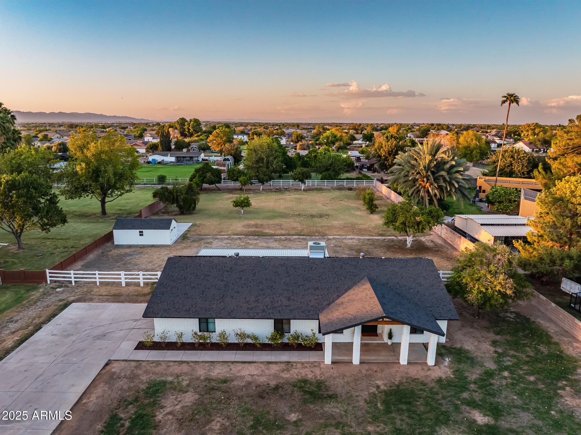 Back on the market! Buyer could not qualify. Appraisal report available at $1M.  Experience refined Arizona country living in this fully remodeled modern farmhouse, perfectly set on a lush, flood irrigated lot with mature citrus trees. Designed with both elegance and comfort in mind, this residence blends timeless charm with high-end finishes throughout.

Step inside to an expansive open layout with natural light pouring through all-new energy-efficient Avanti windows and sliding glass door. Gorgeous oak hardwood floors flow seamlessly across the home, exquisite details like Acarastone Quartz Taj Mahal countertops throughout.  The chef's kitchen is a true showpiece, with a waterfall island, abundant cabinetry, two pantries, and premium appliances for both entertaining and everyday living This home boasts 4 spacious bedrooms plus two additional rooms for office, craft or storage space. One of which includes a large walk-in closet. 3 beautifully appointed baths, and a generous laundry room complete with extensive cabinetry and a fridge. The luxurious primary suite showcases a spa-inspired tiled walk-in super shower, creating a serene retreat.

A rare highlight of this property is the huge basement, offering versatile space for a home theater, gym, or game room. Built for modern efficiency and comfort, the home features spray foam insulation.

With no HOA, irrigated acreage, and space to take in the outdoors, this property blends country serenity with modern sophistication for anyone to enjoy!