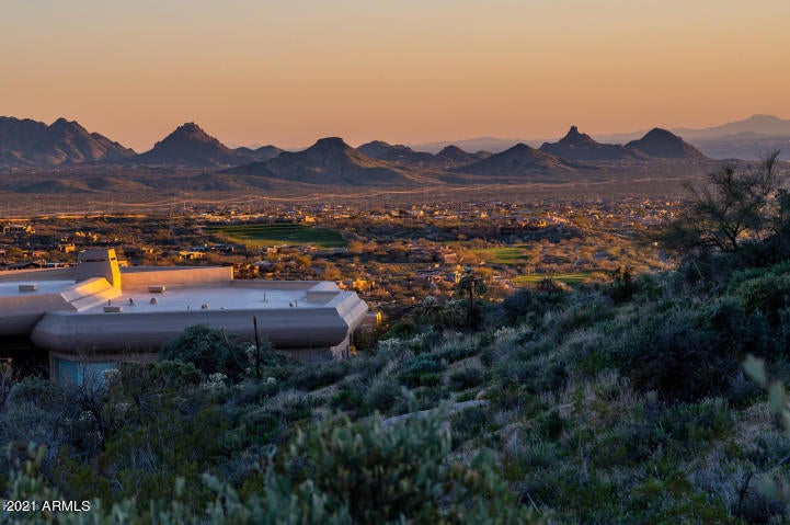 VIEWS, VIEWS, VIES for all angles on this South facing 2+ acre homesite in prestigious Desert Mountain.  You get panoramic views of Pinnacle Peak, Tom's Thumb and an abundance of sparkling city lights!!  This lot has over 28,000 sq/ft of building envelope with plans designed by Cosan Studios to build a Modern 6,125 sq/ft single level home with ZERO steps.  Plans are ready and could be submitted to design review within 2-3 weeks, or take the time and design your own home!!  This lot has some of the best views in all of DM!!