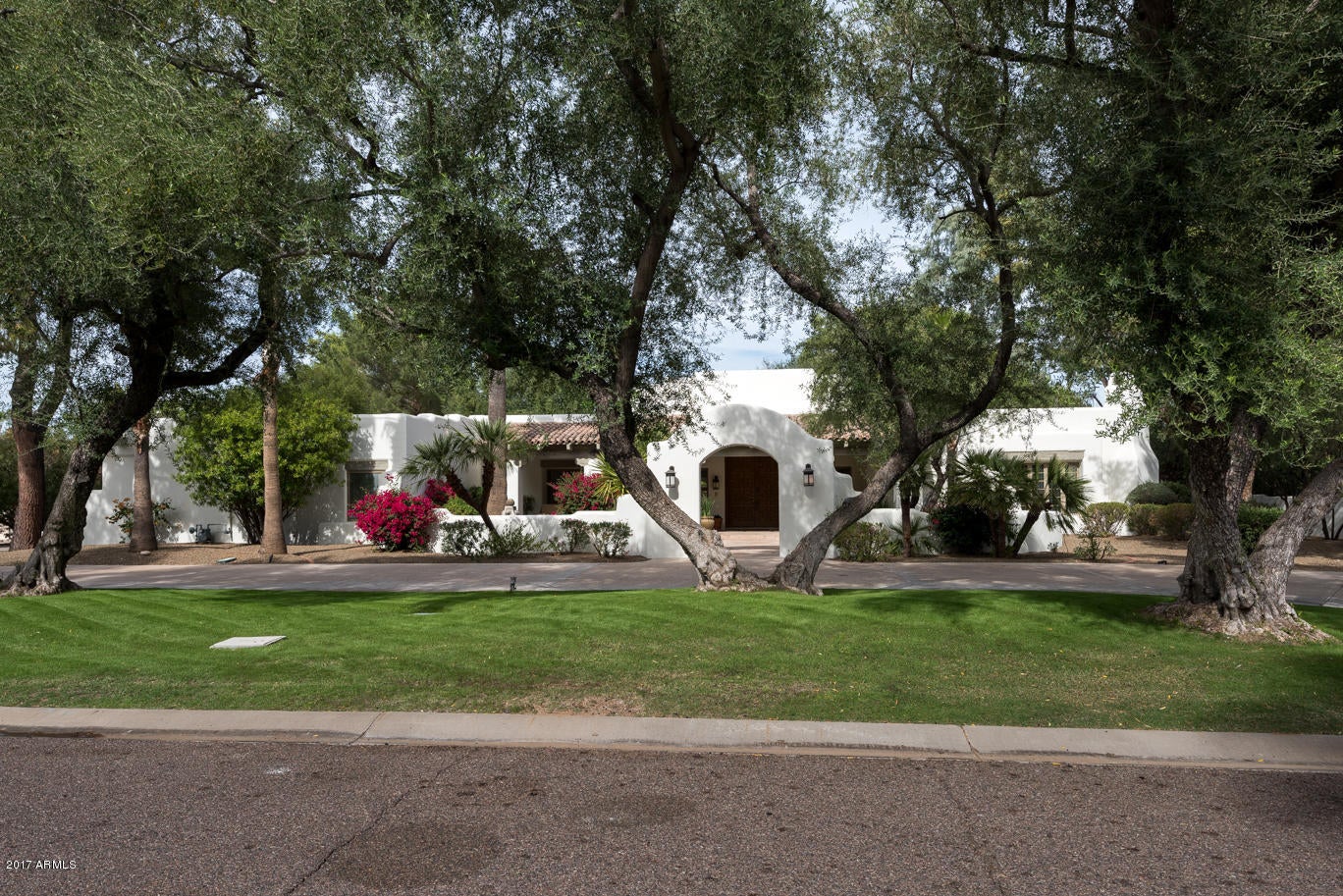 New price adjustment, priced to sell!! Located in the Camelback Country Estates is this wonderful remodeled custom home with a large circle drive greeted with great curb appeal, a beautiful grand foyer and massive living room. Once inside you will see custom wood ceilings in the living room and also offered in the family room and master bedroom. The large kitchen is a chefs delight with all of the amenities you would expect including generous counter top space.  This split floor plan has the master bedroom on one side and three additional bedrooms on the other side of the home, there is an option available if an office is needed in addition to the 4 bedrooms. The backyard looks like a well maintained park with lots of green grass, mature trees and a pool with spa and water feature.