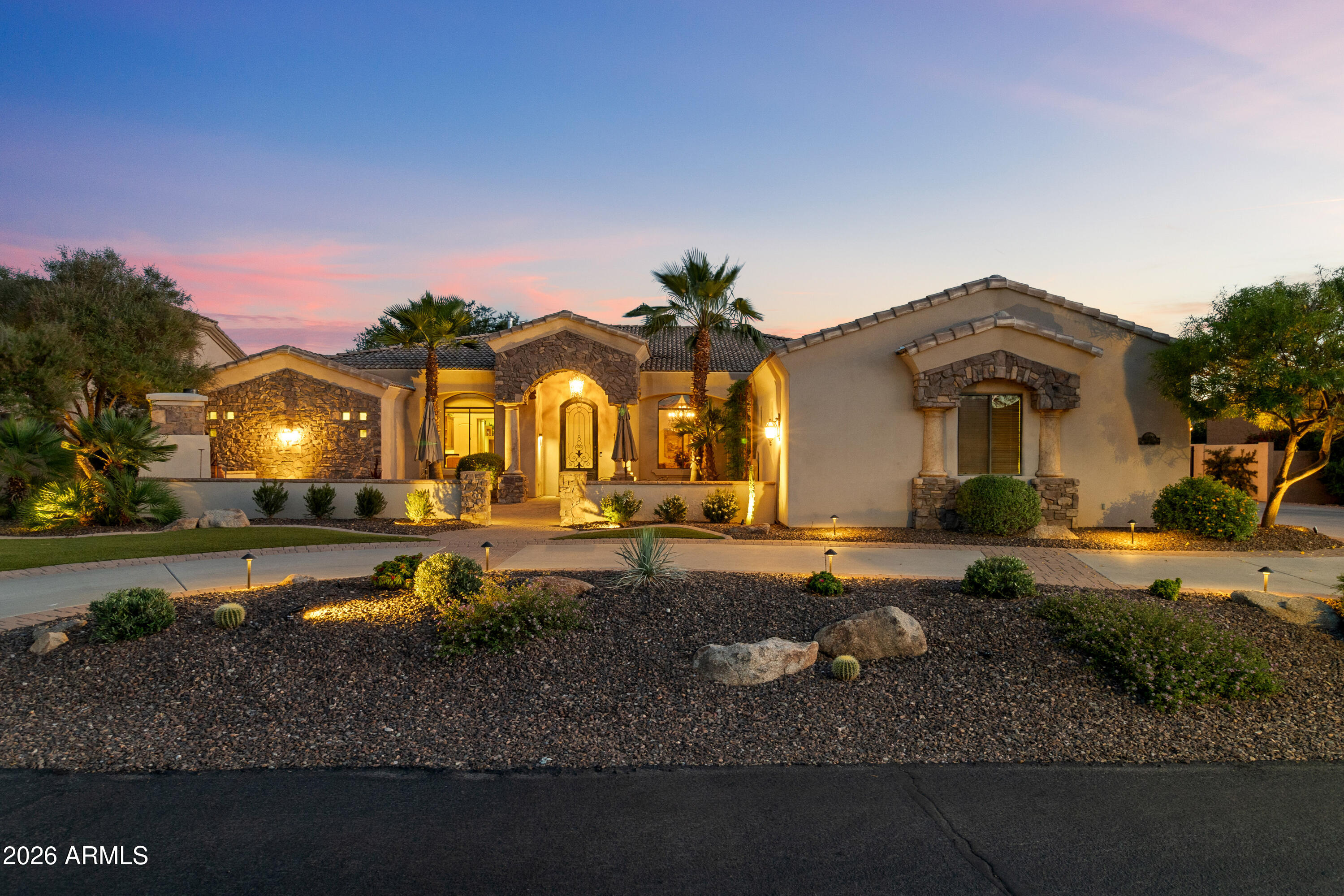 A true statement of craftsmanship, this custom Russell Ranch estate is designed for the discerning buyer. Set on an 18K+ square foot lot with a rare circular drive, the home welcomes you through a private courtyard with stone accents, a fireplace & water feature. Inside, travertine floors, Venetian-style finishes, custom millwork and dramatic ceilings with ambient lighting define the space. The chef's kitchen features an oversized island, premium appliances and custom cabinetry, opening to inviting living areas. The primary suite offers a spa-like bath and generous closets. Entertain with a game room, bar and wine cellar. 

Outdoors enjoy a multi-level pool, fire pit, built-in BBQ and mature landscaping. Abundant privacy to host or enjoy the sunsets in your backyard. 3-car garage with epoxy floors and built-in storage completes this exceptional residence designed for seamless indoor outdoor living.
