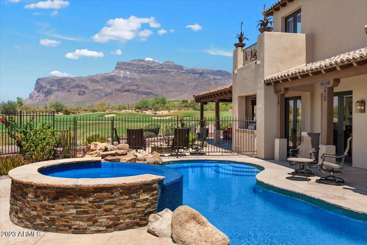 SUPERSTITION SUNSET VISTAS & CITY LIGHTS!
Spectacular home on PRIME lot in Greythorn Village at Superstition Mountain Golf & Country Club. Views overlook the 16th fairway and green of Prospector Golf Course, entire Superstition Mountain Range, and sparkling downtown city lights. Offered turnkey FURNISHED minus personal items. Primary Suite situated on main level with Large Guest suite with balcony upstairs. Heated pool & spa. 3 patios with 2 fire pits and built-in BBQ. Rustic wood & travertine flooring. Eat-in kitchen with granite countertops, breakfast bar, under counter beverage coolers, 6-burner Viking gas stove/oven, Sub-Zero and Bosch appliances, and custom cabinetry. Great room boasts stone wall accent, attractive wood beams, and expansive picture window giving unparalleled views to Superstition Mountains and 16th green. Office has 8ft solid core doors, custom built-in book cases and drawers, and wine coolers. Garage features epoxy flooring, updated garage door, built-in cabinets, and work area. Estimated $150,000 in upgrades over 3 years including flooring, bathrooms, window and door coverings, roof tiles - including warranty, garage door, pavers towards backyard, pool tile sealed, and Orkin Sentricon install [see docs tab]. Private club (membership not included) offers a full service, Tuscan style Clubhouse, 2 Nicklaus designed 18 hole golf courses, tennis, sports club, and pool. Ranked as one of America's 100 Premier Properties by Links Magazine and decorated with "Top 100" accolades from Golfweek, Superstition Mountain has been honored to host numerous major LPGA and Champions Tour Tournaments.