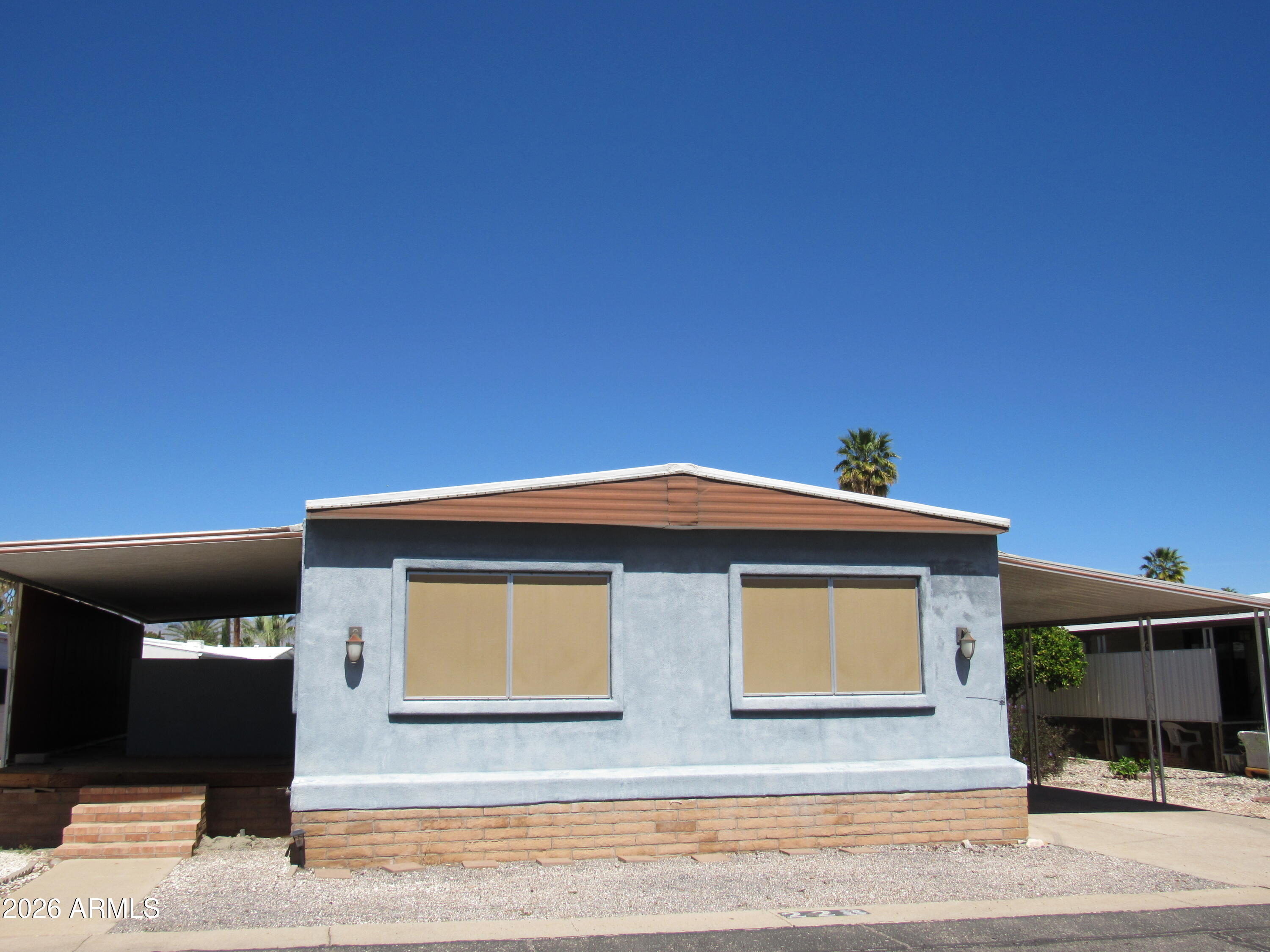 This stuccoed home is situated on a large lot in a quiet square in our gated community.
Textured and painted walls throughout this 2-bedroom, 2-bath home.  Elegant new flooring throughout home.  Large pantry off kitchen. 
Sliders off family area to large unfinished deck and fenced yard. Large living room has dining area with large built-in cabinet for storage or display. Walk in tub and two sinks in primary bath. Walk in shower as well. Walk in shower in second bath.