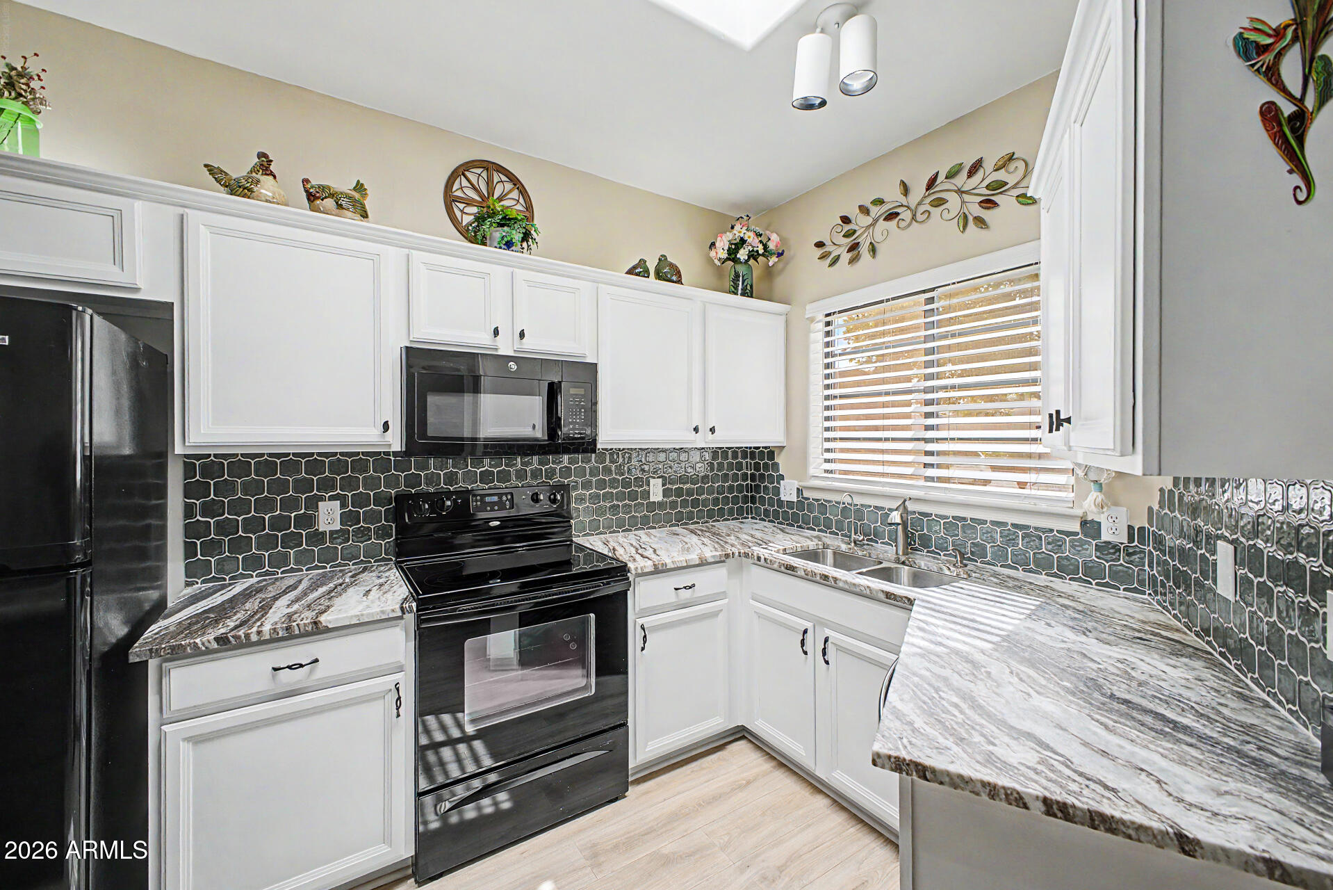 Prime corner lot in sought-after gated 55+ Alta Mesa! This move-in ready gem offers a desirable split 2 bed, 2 bathboth ensuite. R emodeled kitchen featuring modern finishes, island seating, and seamless flow to the dining and great room. Skylights add natural light, while new luxury vinyl plank flooring runs throughout. Major upgrade includes a newer AC unit (2 years old). Enjoy indoor-outdoor living with a spacious covered patio & professionally landscaped backyard W/ low-maintenance synthetic turf. Two-car garage with built-in storage cabinets. Community amenities include heated pool and spa, with HOA covering exterior maintenance and front landscaping. Ideal full-time residence or lock-and-leave retreat near Loop 202, shopping, dining, Cubs spring training, Sky Harbor is 25min!!