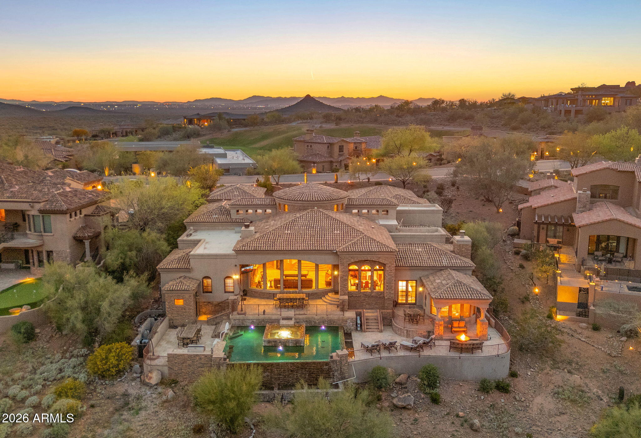 You found it! Located in the gated FireRock Country Club in Fountain Hills, this distinctive Tuscan-style estate sits along the 4th fairway with sweeping golf course and mountain views. A dramatic foyer with a fountain atrium opens to elegant interiors featuring Cantera stone, travertine floors, and groin-vaulted ceilings. The gourmet kitchen offers a 6-burner Wolf double oven, custom cabinetry, granite counters, and a 250-bottle wine cellar. The luxurious primary suite includes a fireplace, breakfast bar, writing retreat, and spa bath with Grecian Cantera columns and jetted tub. A separate guest wing and private casita provide comfort and privacy. Outdoors enjoy a wraparound pool with six negative edges, island spa and multiple seating areas designed to capture Arizona sunsets.