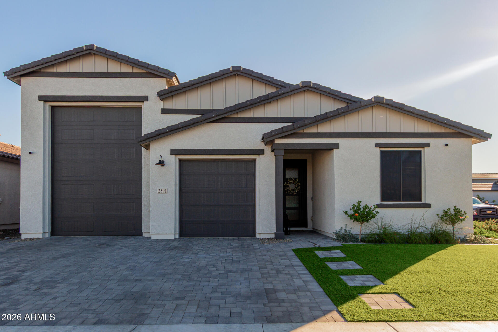 Why wait on a builder when the best home in the community is already finished with RV Garage.  Located in a highly sought-after new build community still under active construction, this completely finished, impeccably maintained residence offers a rare opportunity to move right in without delays, dust, or decision fatigue.
This home shows better than the model and has been thoughtfully upgraded far beyond standard builder offerings. The front and backyard are fully landscaped, creating a true turnkey experience that most new builds simply cannot offer. Entertain with ease thanks to a custom outdoor space complete with a built-in grill, perfect for Arizona evenings. Inside, the home is immaculate and meticulously cared for. The kitchen features upgraded appliances, while the living space is anchored by a stunning fireplace with a designer accent wall, adding warmth and visual impact. The garage is fully outfitted with built-in storage, and the attached RV garage provides exceptional functionality for toys, trailers, or additional workspace. Wood shutters have been installed throughout the home, a pricey and beautiful option that would normally cost thousands!

Every detail has already been doneno waiting on landscaping, no post-close upgrades, no surprise expenses. This is new construction living without the wait, offering immediate enjoyment in a community that's still being built around it.

Truly move-in ready, beautifully upgraded, and flawlessly maintained, this is the one buyers hope to find but rarely do.