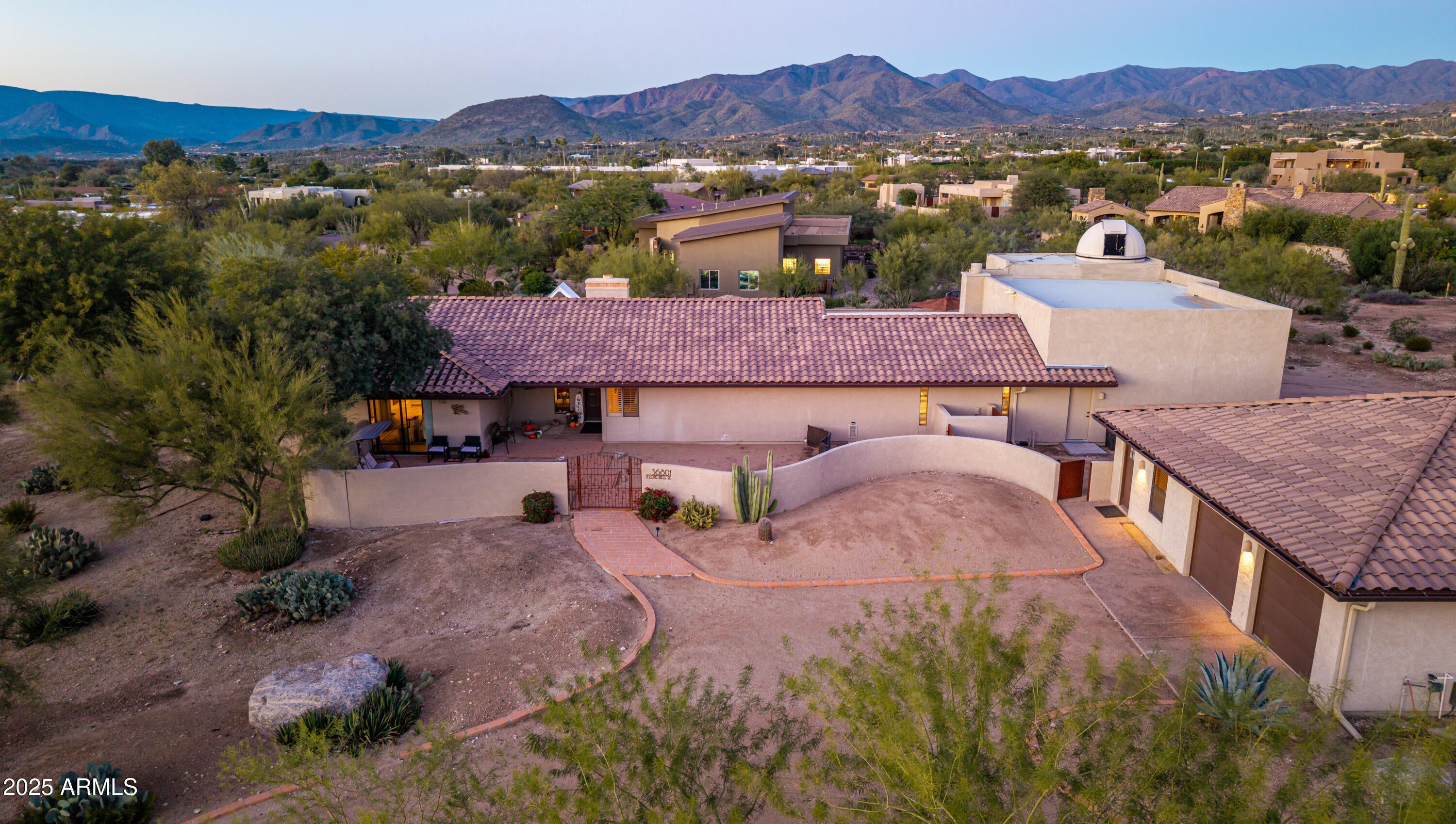 Beautiful Carefree property with no HOA, offering 5 bedrooms, 4.5 baths and a remodeled detached casita. The home features wood-look tile flooring, beamed ceilings, a fireplace, and an updated kitchen with white shaker cabinets, roll-outs, refrigerated drawers, double ovens, a pot filler, and a large 9x12 walk-in pantry. Enjoy a full-length covered patio with an outdoor fireplace, BBQ area, and heated pool. The property includes an RV garage with electric hookup and 7 total garage spaces. Recent updates include a new roof, newer HVAC components, fresh interior and exterior paint, updated septic equipment, new gutters, and upgraded patio flooring. Additional highlights include a private office, fenced yard areas, and a separate observatory.
