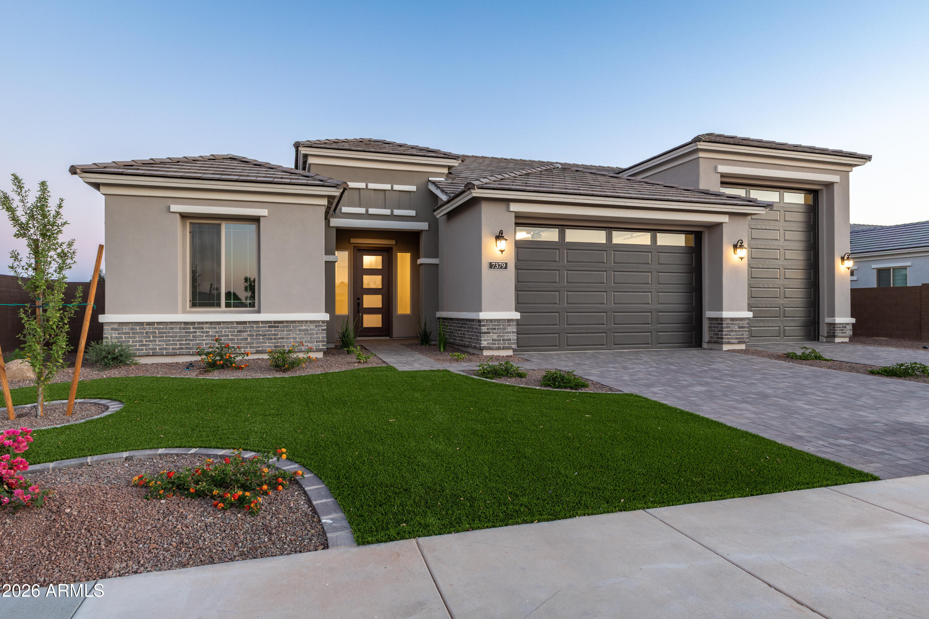Let's talk about RV Garages! This new home at Acoma Estates has a top-shelf 74' RV garage with 16 ft ceilings and a 12x14 door! This means you'll finally have room for all the toys with room to spare! And the home? Extraordinary in every way with professionally designed finishes and appointments rarely seen at this price. White and natural Ash-stained cabinets with sleek modern matte black fixtures, fans and hardware; custom millwork wall designs; impressive flooring, coffered and beamed ceilings, GE Monogram appliances including refrigerator; All of this and more on a perfect north/south corner lot already landscaped to perfection plus an extended covered patio. So back in the rig and start really living!