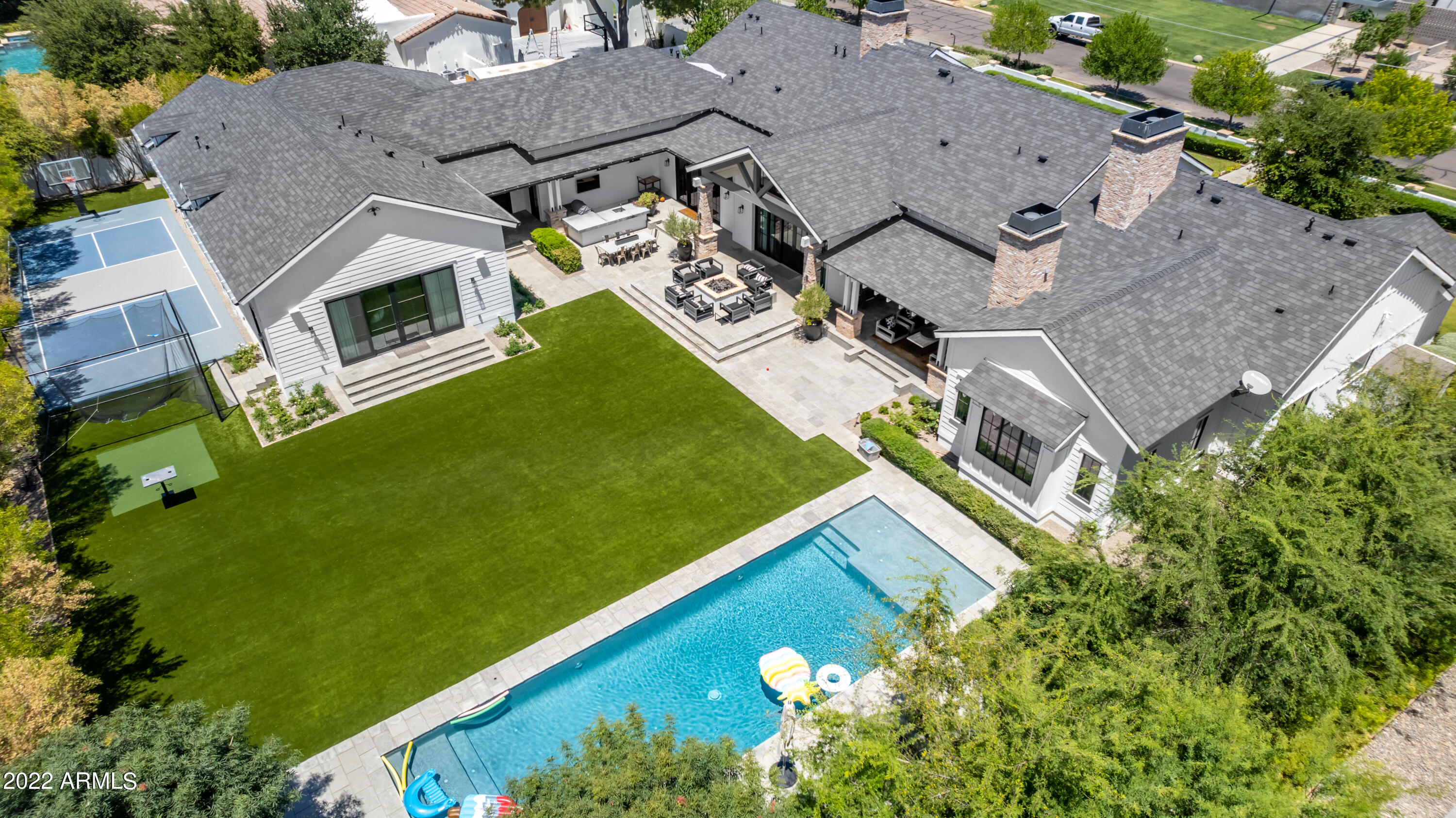 Two of the Valley's best builders crafted this quintessential Arcadia high ceiling modern ranch to perfection. Newer Brimley build was then expanded and improved by Regal American to include 5 bedrooms 5 bathrooms in the main home, kids play room & art/ homework room, air conditioned garages and gym/ massage room and brand new two bedroom guest house with full kitchen and high tech perfect secret husbands golf viewing room hidden above the guest house complete with safe. There has never been another launch with such spaces on Exeter. Batting cages, low care turf yard, resort Hamptons style heated pool with Baja shelf, sport court, outdoor pool restroom. Beautiful indoor and outdoor slider doors and entertainment patios. Custom high tech hidden door to husband's dream golf viewing tv room.