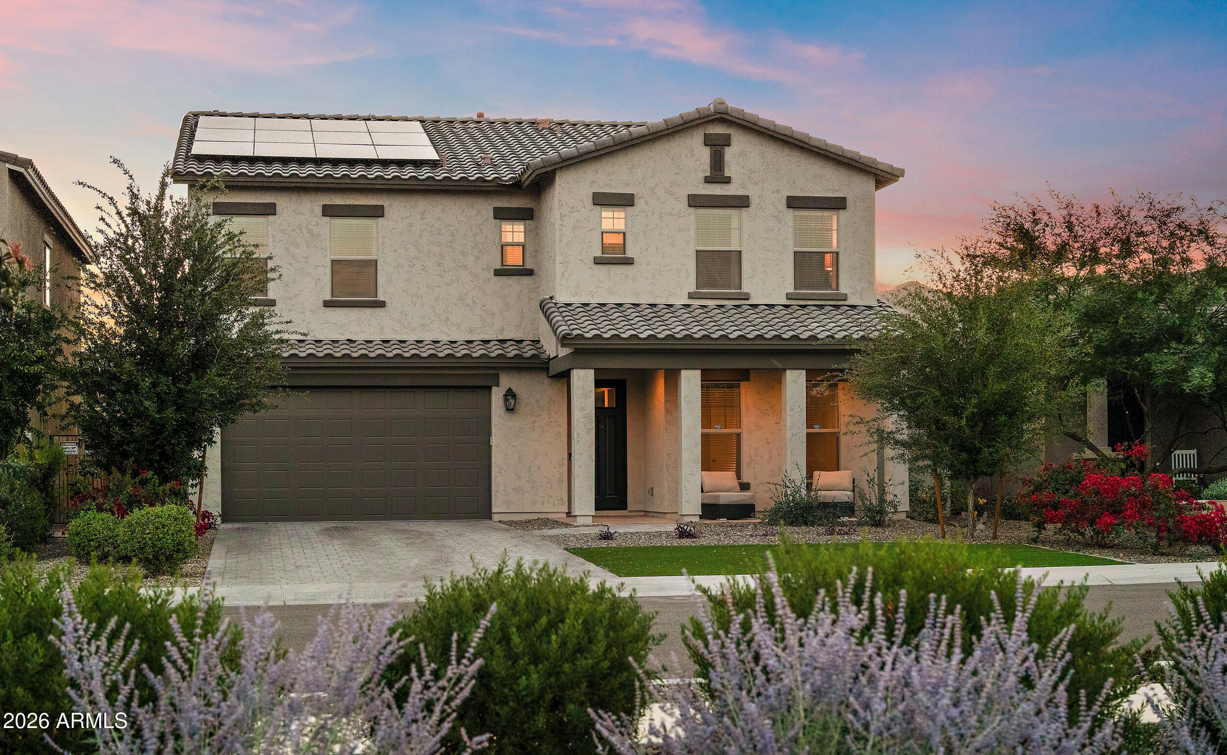 Framed by stunning mountain views and enhanced with energy-saving solar, this beautifully appointed residence offers a refined blend of luxury and comfort. The sought-after Benbrook floor plan showcases an open-concept main level with a spacious great room, 12' fully retractable glass wall, extended patio, private study, and guest suite. At the heart of the home, the gourmet kitchen impresses with built-in stainless steel GE appliances, gas cooktop, chimney hood, elegant quartz counters and 42'' upgraded cabinetry. Upstairs, the serene owner's retreat features a spa inspired oversized walk-in shower, dual split vanities and expansive walk-in closet. It's also complemented by a versatile loft and well-appointed laundry room with premium washer and dryer and built-in cabinetry. Thoughtfully upgraded throughout with whole-home water filtration RO + alkaline system, smart thermostats, integrated security, custom window treatments and upgraded ceiling fans in every room. Additional highlights include a 2-car garage with custom overhead storage, pre-plumbed gas line for outdoor living, raised block walls for added privacy and professionally landscaped grounds with WiFi capable irrigation. A truly exceptional home offering elevated living in one of the area's most desirable communities. Troy Gilbert Elementary School to be opening fall of2026.