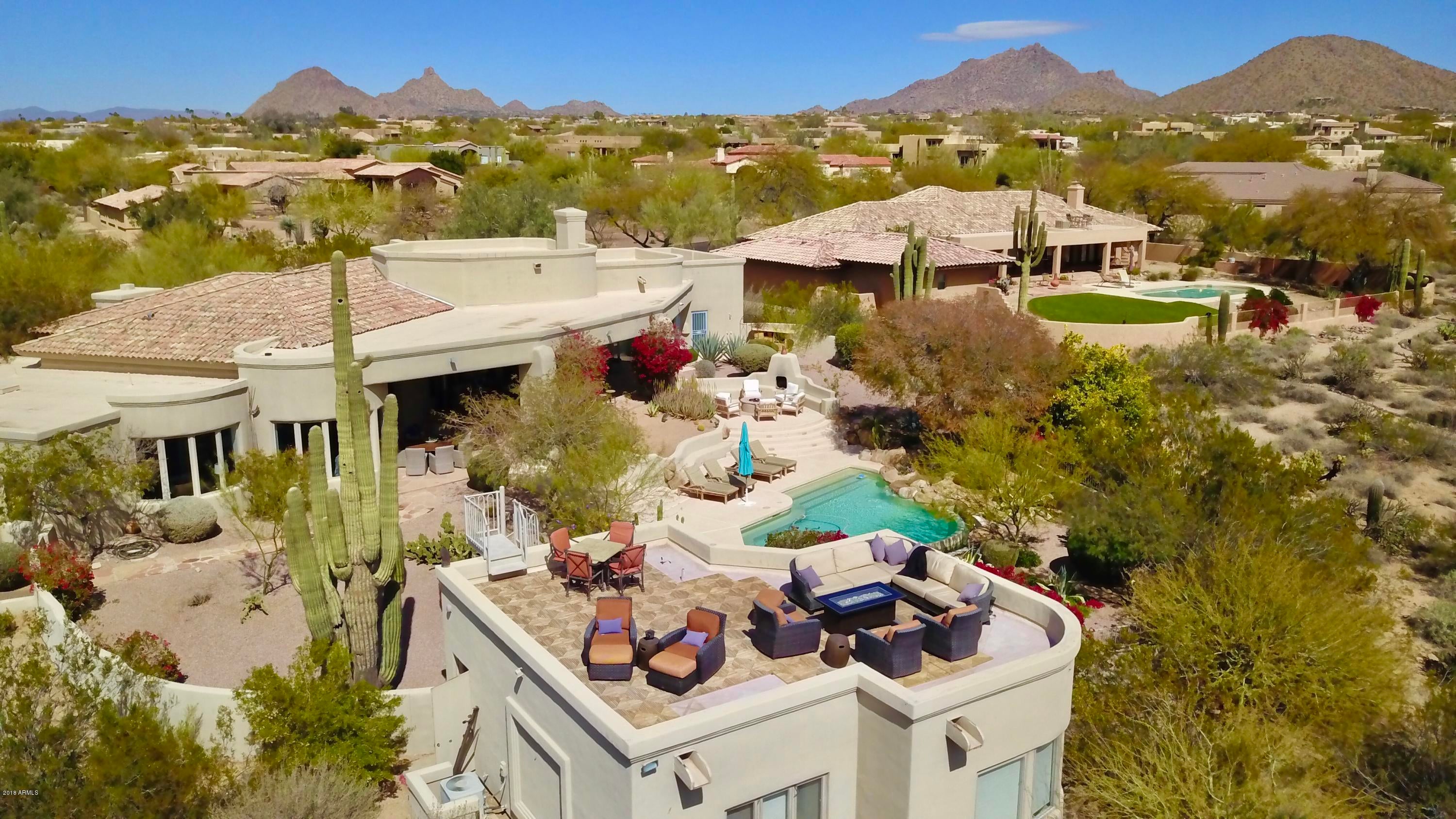 This Salcito masterpiece is situated on a prime North Scottsdale acre lot offering quality throughout. Open floor plan, numerous amenities, stunning views of the McDowell mountains & city lights all while overlooking the prestigious DC Ranch ! Completely remodeled kitchen 2017 includes a wine room & bonus cigar room.  The main house features a great room with a grand fireplace & wet bar. The master bedroom with mountain views is split from 2 spacious bedrooms that share a Jack & Jill bathroom & steam shower.  There is a separate office/den & formal dining/pool room. The fully remodeled 600-sq.ft. guest house with kitchenette is a place all friends and family will love to stay.  The terrace above is a place all the family can enjoy together while taking in the 360 degree views of the Sonoran Desert. From the main house French doors lead to an impressive covered patio & lush terraced backyard w/ fireplace & firepit, heated negative edge pool & built-in BBQ , perfect for entertaining. Updates include wood, marble & travertine flooring thru out, granite counters, master soaking tub, interior paint, epoxy garage flooring & refinished cabinets.  This is a stunning home situated on what could be one of the best lots in North Scottsdale.