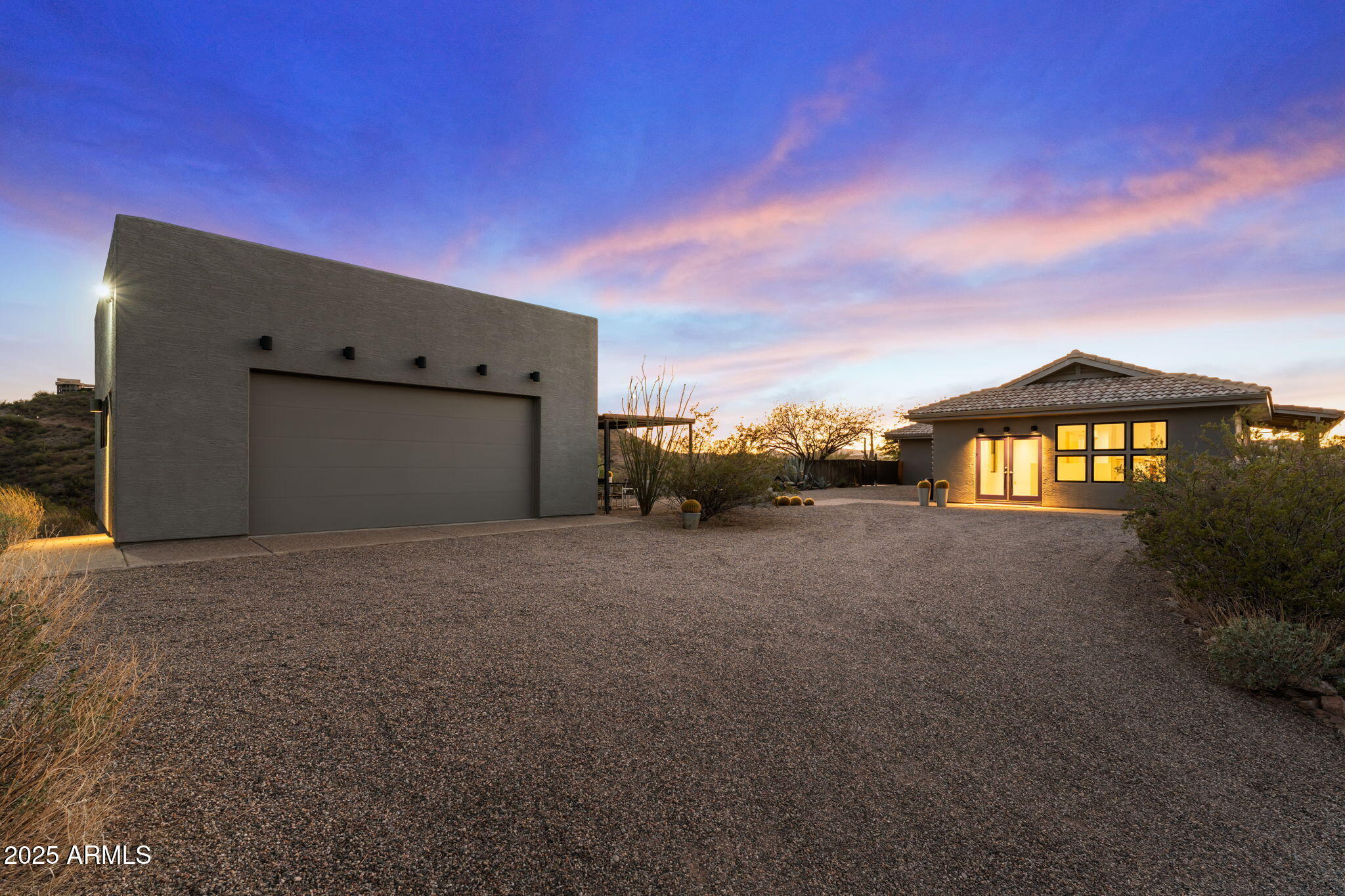 Experience the best of Arizona living in this gorgeous 3,284 sq ft home designed to take full advantage of its breathtaking surroundings. Boasting 5 spacious bedrooms, 3 bathrooms, and an over-height 2-car garage, this property combines style, functionality, and privacy on 4.5 pristine acres—with no HOA! Inside, you'll find two levels of flexible living space, perfect for multi-generational living or guest accommodations. The home features beautiful travertine tile flooring and plush new carpet, fresh interior paint, and modern fixtures that create a sleek, contemporary feel throughout. The kitchen is both elegant and functional, offering granite countertops, updated stainless steel appliances, a butler's pantry and ample cabinetry and storage. Bathrooms echo the same luxury finishes with granite surfaces and refined details. Step outside to your personal oasis - an inviting fenced, heated pool and spa complete with a variable-speed pump and free-standing cover roller. Multiple patios, a large balcony, and a covered seating area provide endless options for outdoor entertaining or simply relaxing while soaking in the unobstructed 360° desert and mountain views. The fenced backyard, carport, and low-maintenance desert landscaping make this property both beautiful and practical. With a private well and septic, utility costs stay low, leaving you more freedom to enjoy your surroundings. Whether you envision a workshop, guest casita, or horse facility, the possibilities are endless - the sky truly is the limit on this incredible, view-filled property! Come see why this desert gem is the perfect blend of luxury, comfort, and opportunity!