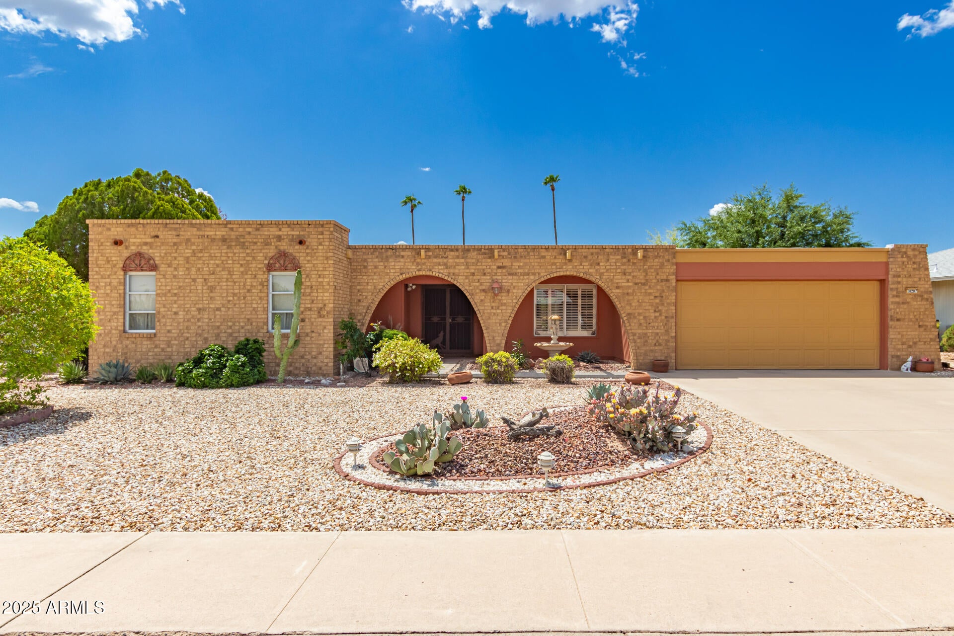 Experience delightful adult living in this 2-bedroom residence located in Sun City! You're welcomed by a 2-car garage, a charming brick facade, and a lovely desert landscape. Discover a living/dining room with soaring ceilings, rustic exposed beams, a textured palette, tile flooring, and a stone-clad fireplace. The eat-in kitchen boasts skylights for abundant natural light, a tile backsplash, flat-panel wood cabinetry, a pantry, and essential built-in appliances. Spend quiet afternoons in the cozy sunroom,  perfect for enjoying the warm Arizona weather year-round. The primary bedroom offers soft carpeting, a make-up vanity, a private bathroom, and a walk-in closet. Unwind at the end of a long day in the backyard, which includes a covered patio for al fresco dining.  Living in Sun City you will enjoy access to one of Arizona's most established and amenity-rich active adult communities, designed around connection, convenience, and an engaging lifestyle. At the heart of the community are multiple recreation centers that serve as social and activity hubs, offering everything from fitness centers, indoor and outdoor pools, and group exercise classes to hobby studios for ceramics, woodworking, and arts and crafts. Whether it's joining a yoga class, playing cards, or learning a new skill, there are countless ways to stay active and involved year-round.

Beyond the recreation centers, Sun City offers a truly vibrant lifestyle with golf courses, tennis and pickleball courts, bowling, billiards, walking and biking paths, and scenic lakes throughout the community. Residents can participate in a wide variety of clubs and social groups, from fitness and sports to creative arts and social gatherings, making it easy to meet others and stay engaged. With beautifully maintained spaces and activities for every interest level, Sun City creates an environment where residents can enjoy both relaxation and an active, connected lifestyle close to home.