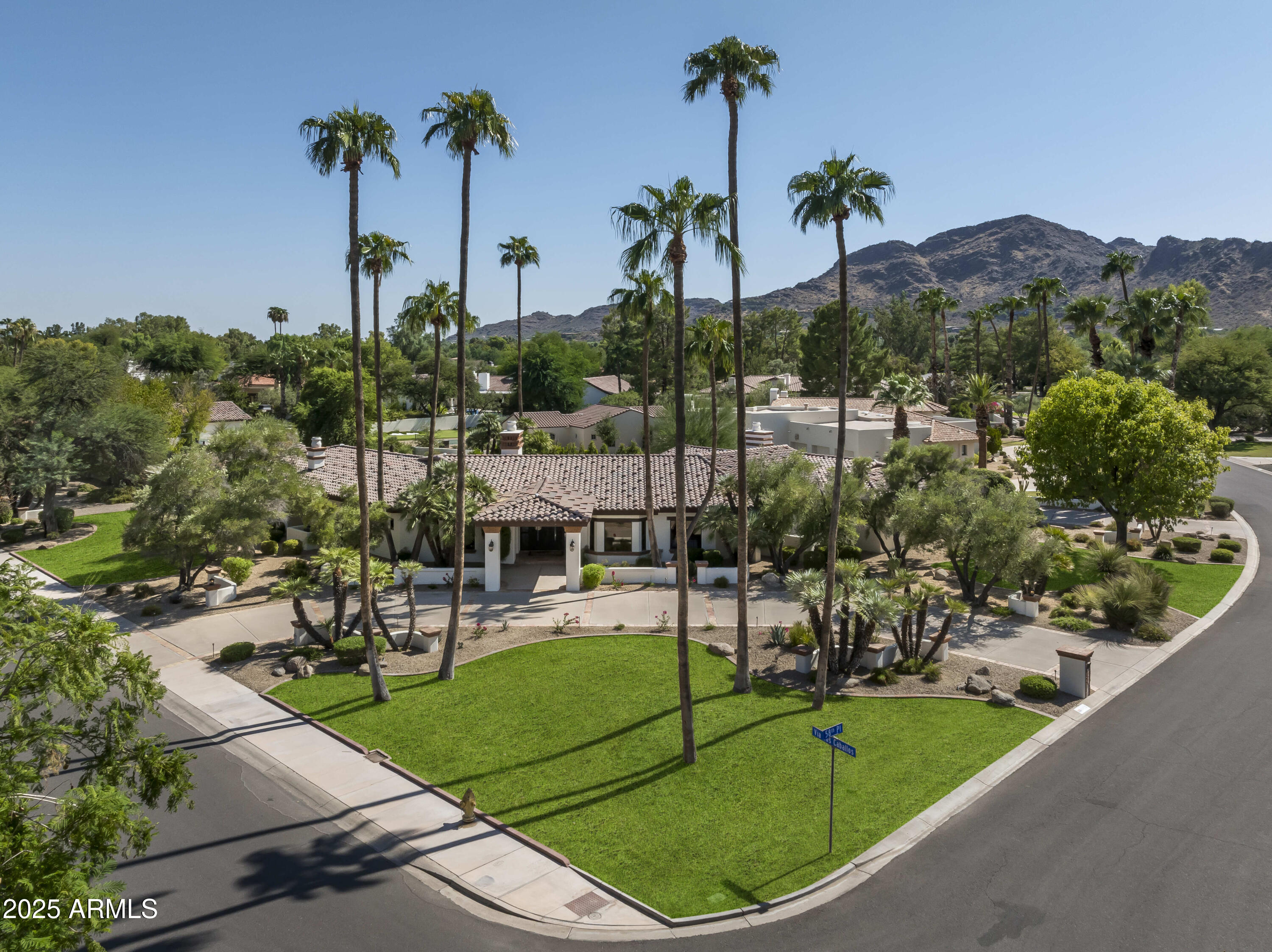Located in the prestigious sought-after neighborhood of Camelback Country Estates in the 3 C's school district, this charming newly updated property with large grassy area and sport court boasts a perfect floor plan with five ensuite bedrooms, including an attached guest house, plus a separate paneled library. The luxurious primary suite features two new his and her bathrooms, dual custom closets, an exercise room and sauna. Set on a full acre, the expansive grounds offer a fire pit, multiple patios and a brand new pool (owners dug out and moved the location of the new pool). Recent upgrades include fabulous  3,000 sq. ft. of hardwood floors, a lovely remodeled kitchen with quartz counters, new landscaping and a new roof (2021) with a 15-year transferable warranty!