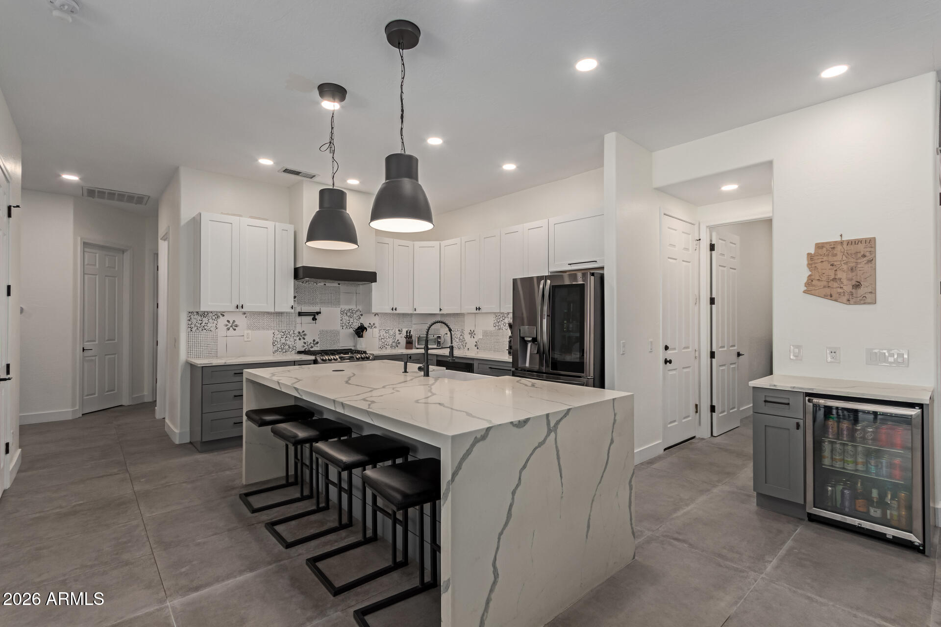 This home is a rare find in Desert Ridge! Completely Remodeled in 2020, this 4 bedroom 2 bath home features countless upgrades including Large format Italian tile throughout the main living areas, Solid wood floors in all the bedrooms, LED lighting throughout, huge chefs kitchen and much more. The backyard was complete leveled in 2024, pool was remodeled with all new mini pebble liner, new pool filter and a large outdoor kitchen. New Roof in 2016, new AC units in 2020, Quartz countertops throughout, and much much more! There is also a hidden room that was used as a podcast studio!! Nearby conveniences - JW Marriott, Wildfire Golf Course, Desert Ridge Marketplace, High Street plus Loop101 access. North South exposure.