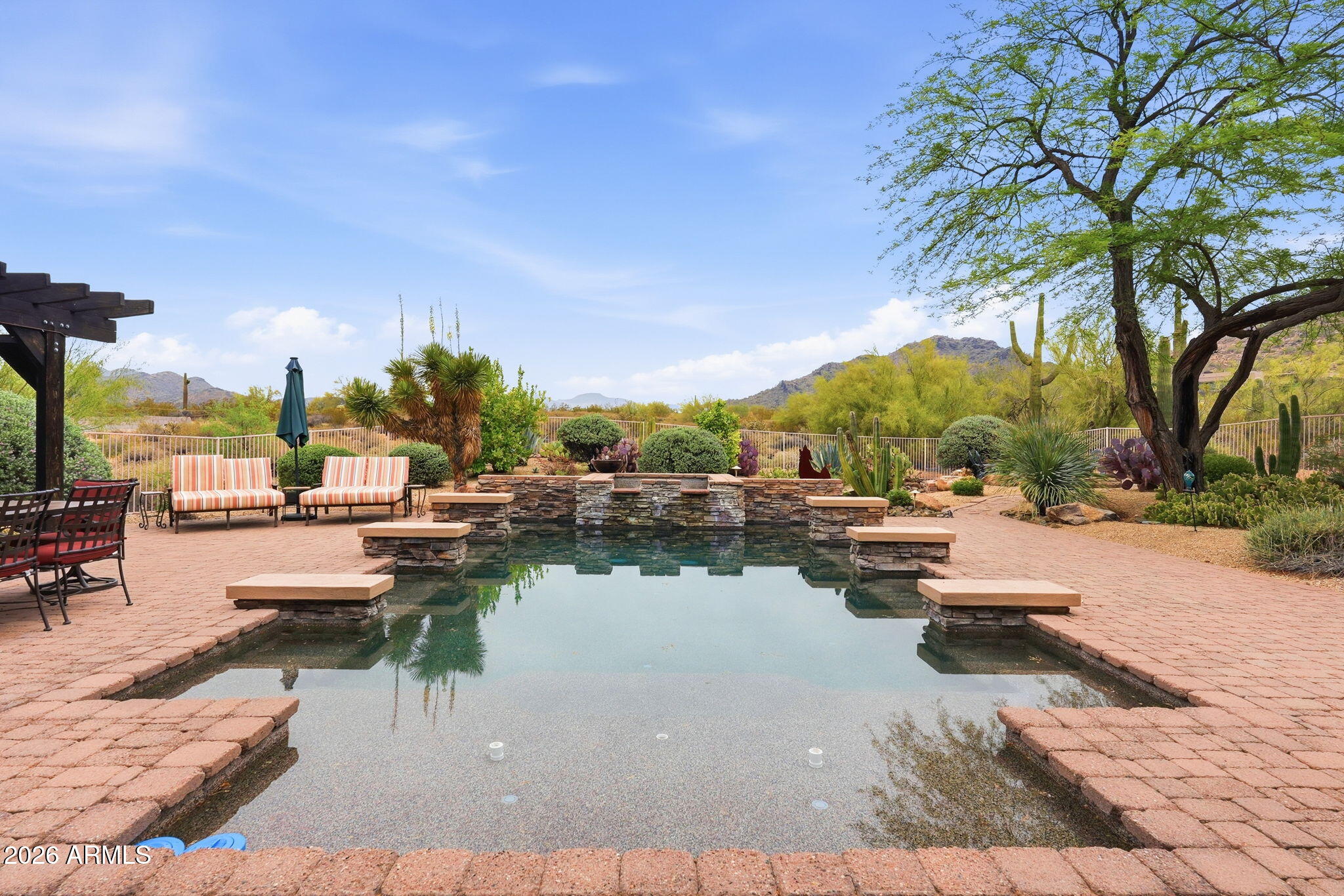Luxury desert retreat on over an acre in Cave Creek with stunning mountain views. This custom home features a split floor plan with 4 ensuite bedrooms, spacious living areas, and high-end finishes throughout. Gourmet kitchen opens to great room, perfect for entertaining. Automated retractable glass wall creates seamless indoor/outdoor living to an oversized covered patio. Resort-style backyard includes heated pool, spa, outdoor kitchen, and multiple seating areas. Primary suite offers spa-like bath with soaking tub and dual walk-in closets. Additional highlights include smart home system, private theater, travertine flooring, custom cabinetry, and 3-car climate-controlled garage. Premium homesite offering privacy and breathtaking Sonoran Desert surroundings. This is the perfect spot for an AirB&B which it has been used for the past 3 years and is very successful. Home was originally built for a Microsoft exec, so the home has GI panels controlling the lighting, shades, climate, media & security. You will fall in love with the 20ft. Livingroom window wall door opening up to your backyard sanctuary to include an outdoor kitchen! So much more-You don't want to miss this one!