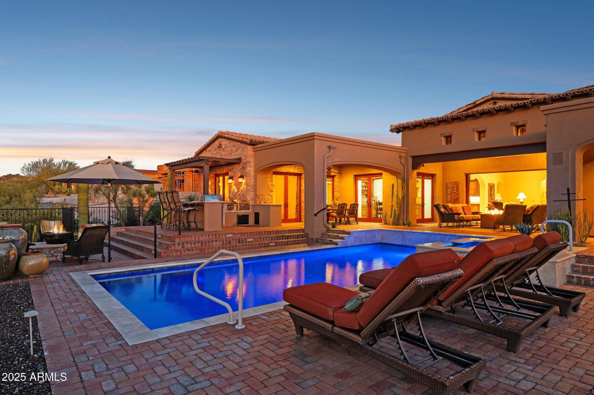 FULL GOLF MEMBERSHIP avail. subject to approval. Exquisite Spanish Hacienda inspired residence crafted with exceptional attention to detail. Soaring ceilings and an expansive great room w sliding pocket doors creates a seamless transition from indoor living to a private, resort caliber outdoor oasis where sweeping mountain & sunset panoramas frame the 7th hole of Mirabel Club golf course. A thoughtfully designed floor plan places the primary suite & a dedicated office on one wing while two guest bedrooms occupy the opposite side. A spa-like primary bath offers an oversized steam shower. A fourth bedroom functions as an attached casita. The below grade temp controlled, walk-in wine cellar is an ideal wine tasting room. Behind the gate you will find a private motor court w golf cart garage.