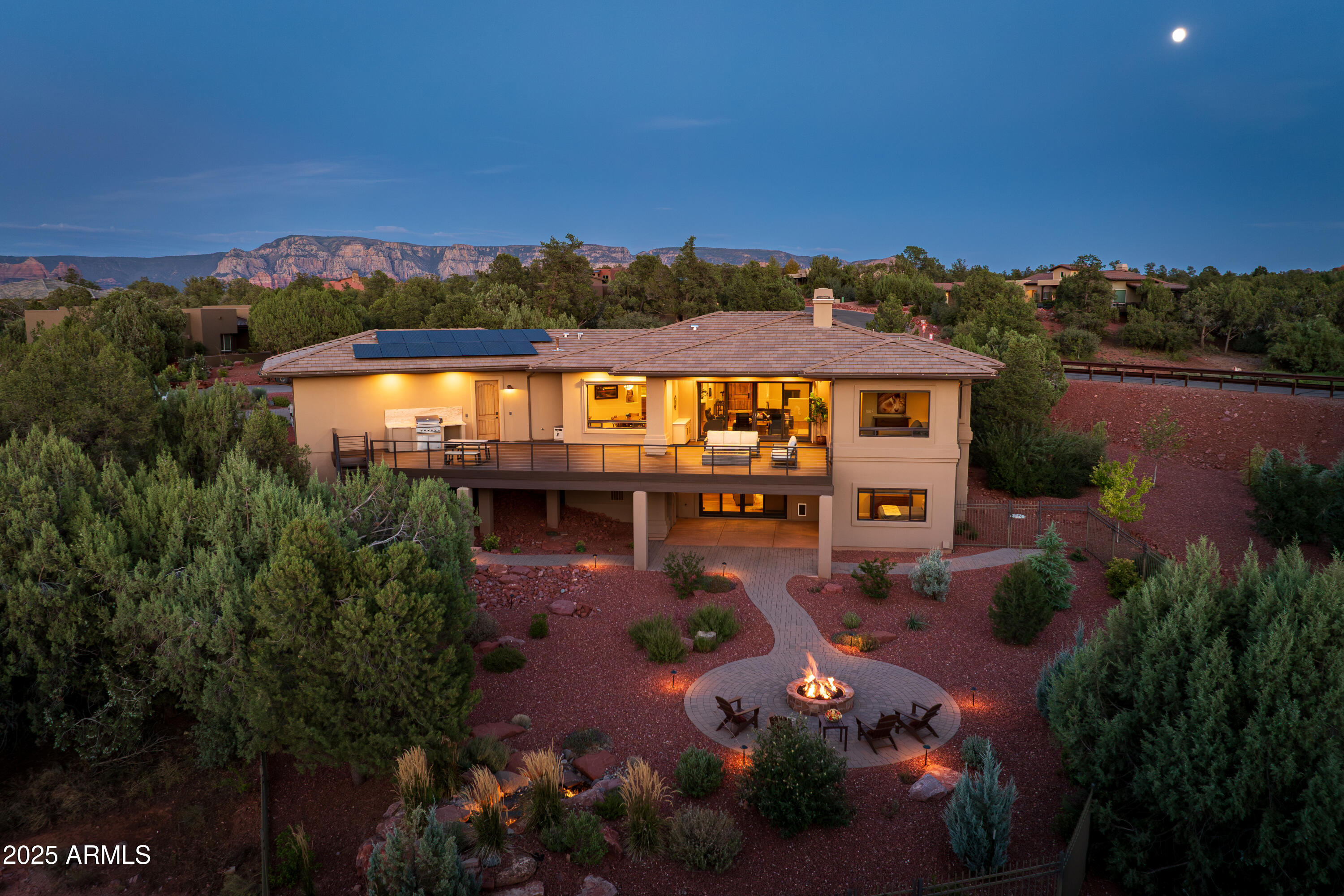 UPGRADED LUXURY REMODEL with stunning Sedona red rock views. This 4 bedroom residence offers a huge media room, 2.5 bathrooms, and 3,405 SqFt of beautifully designed, energy efficient living space. Enjoy unforgettable sunsets from the expansive NEW Trex wraparound deck featuring a gas fire-pit, built in BBQ, and dedicated plumbing and electrical for a future hot tub. The recently landscaped backyard includes a second fire-pit and a waterfall that is beautifully illuminated at night. Inside, the home showcases Mont Blanc quartzite countertops, Miele and Thermador appliances, motorized shades, custom Alder cabinetry, remodeled bathrooms, custom closets, and designer lighting throughout. Every detail reflects refined craftsmanship and thoughtful luxury. Energy Star certified & owned solar! New Feng Shui water feature at front entry installed 12/25. Two water features provide the ultimate ambiance.

Some designer furnishings are available for purchase separately. Brochure and complete list of upgrades are available in the MLS.